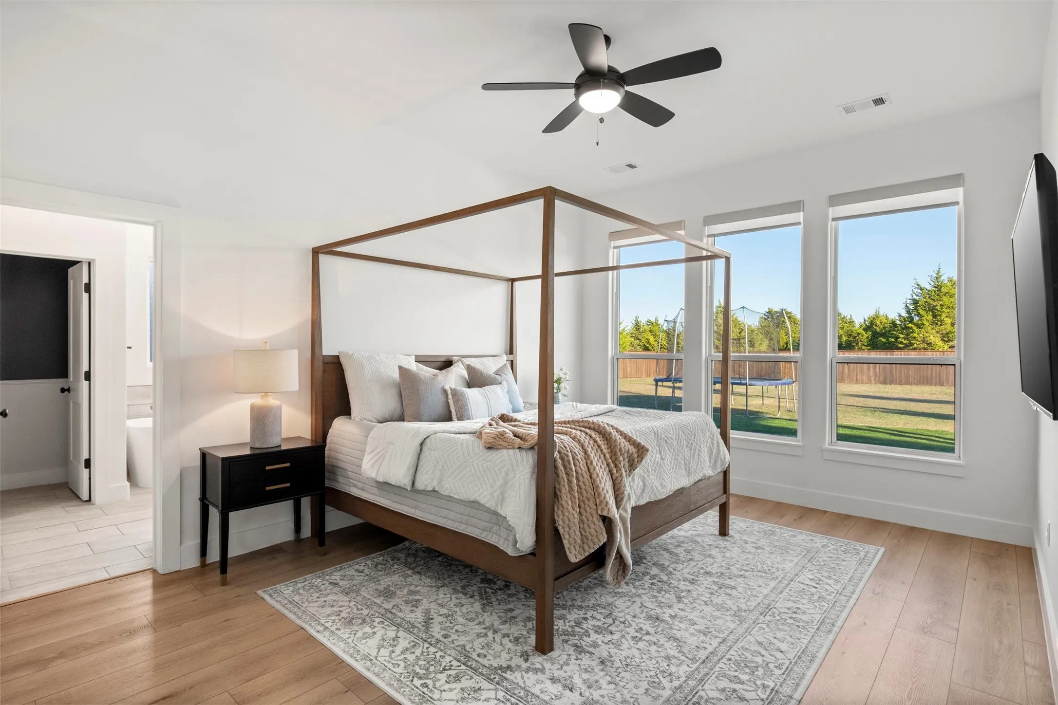 Primary suite with generous natural light and views toward the backyard.