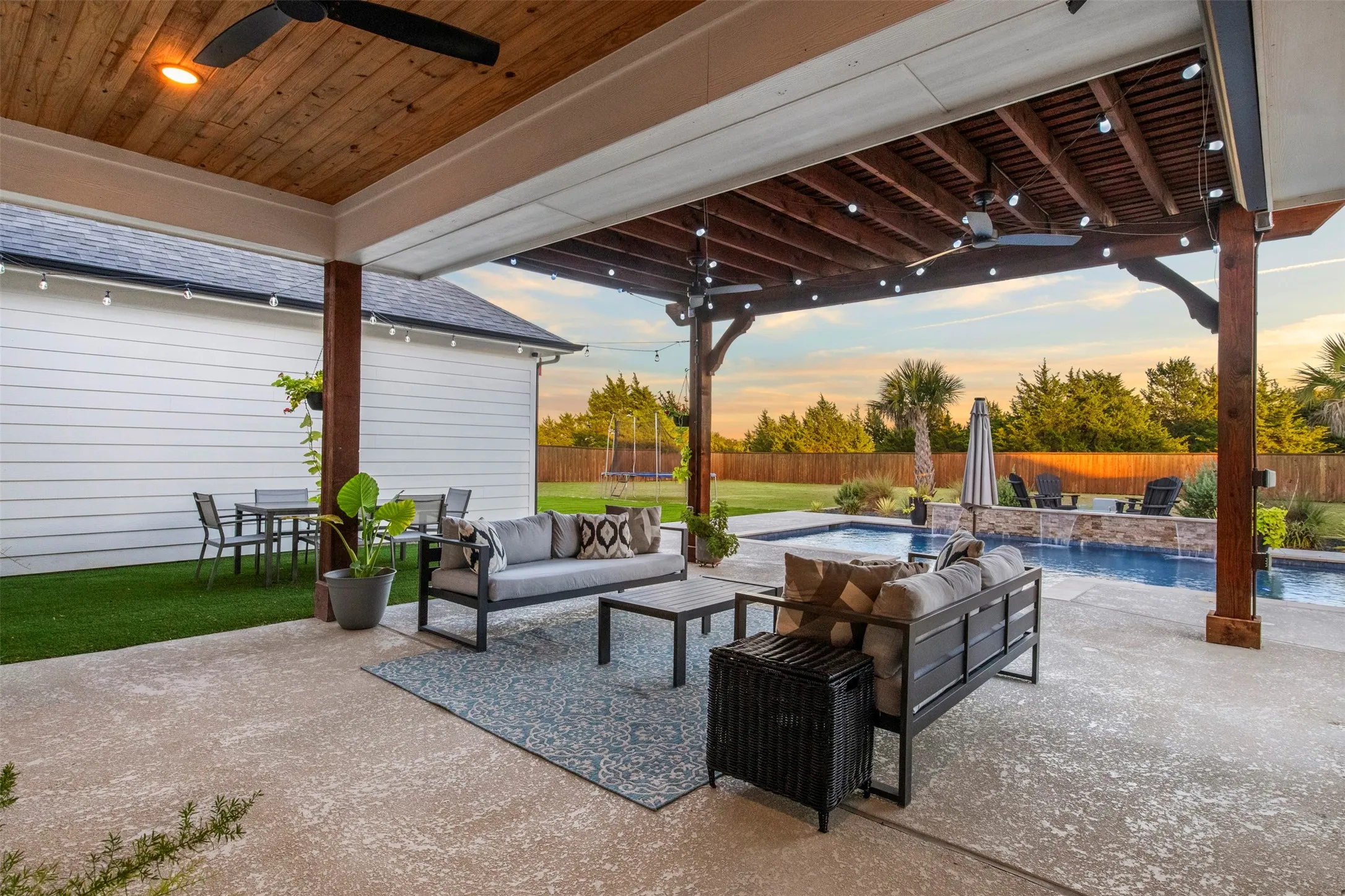Extended cedar pergola creates additional shaded entertaining space.