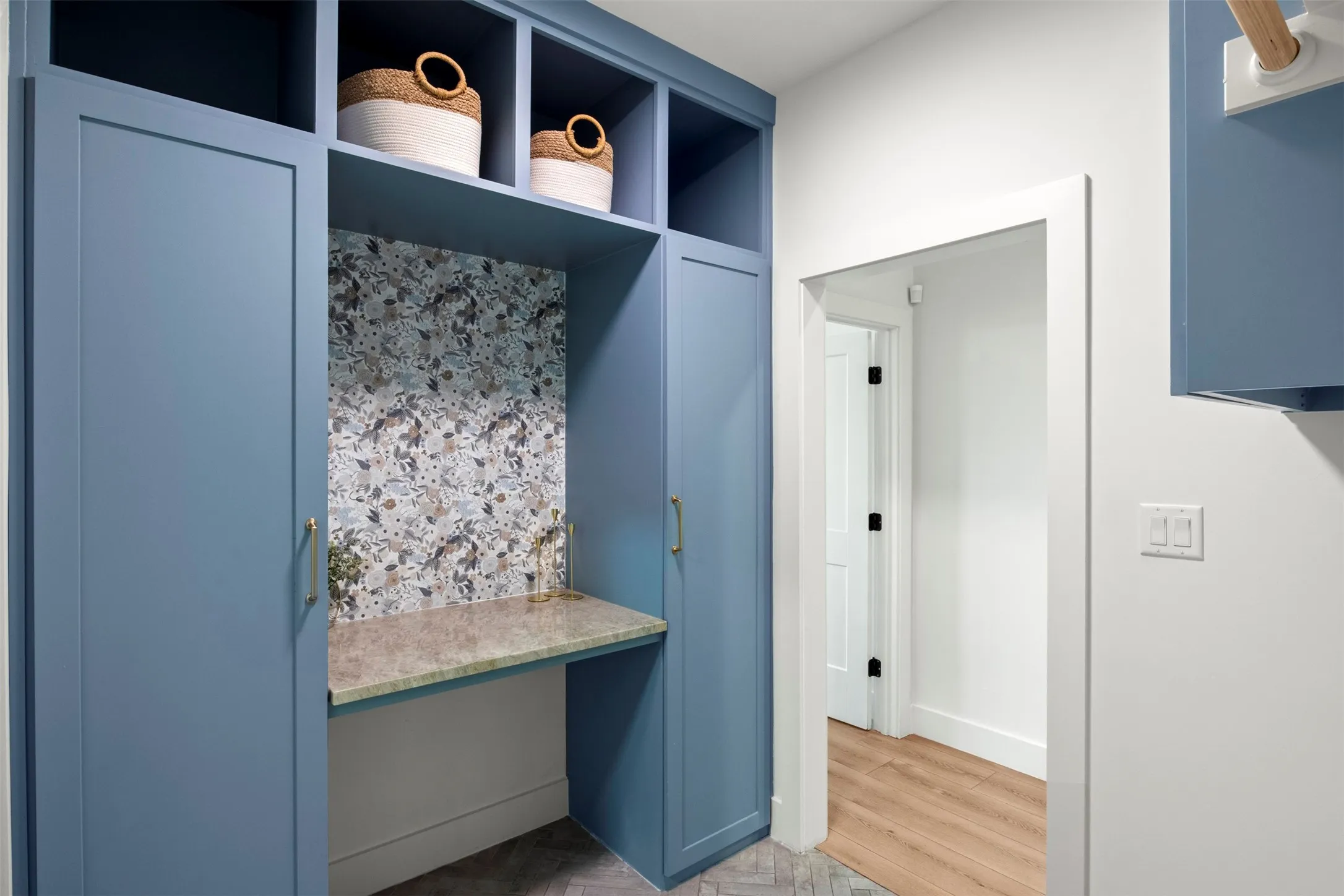 Convenient direct connection between the laundry room and primary closet. Custom blue cabinetry adds style and practical storage.