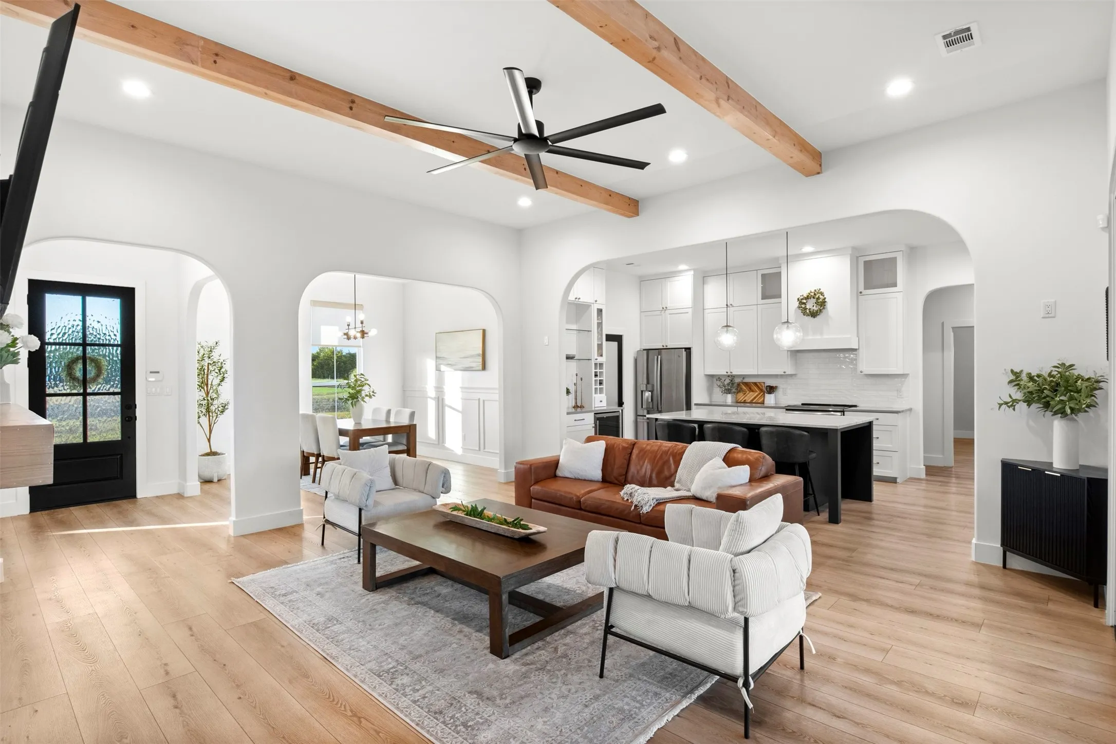 Open-concept design connects the main living area to the kitchen and dining spaces.