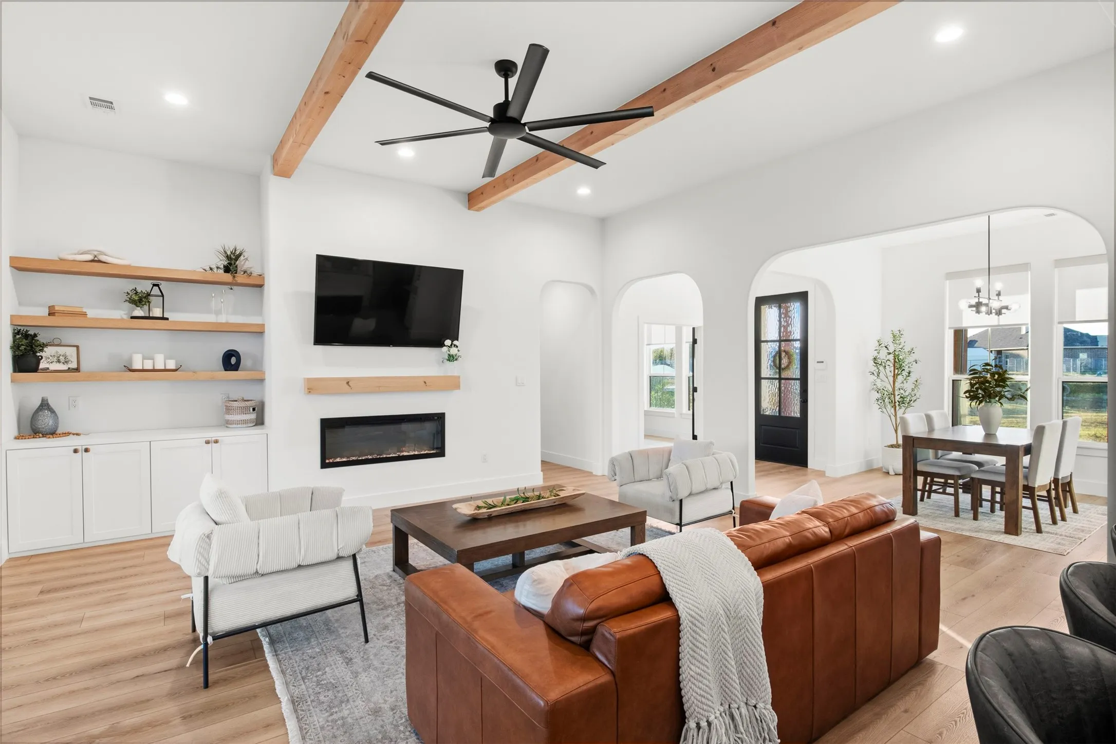 Fireplace, built-in cabinetry and arched openings add character and functionality.