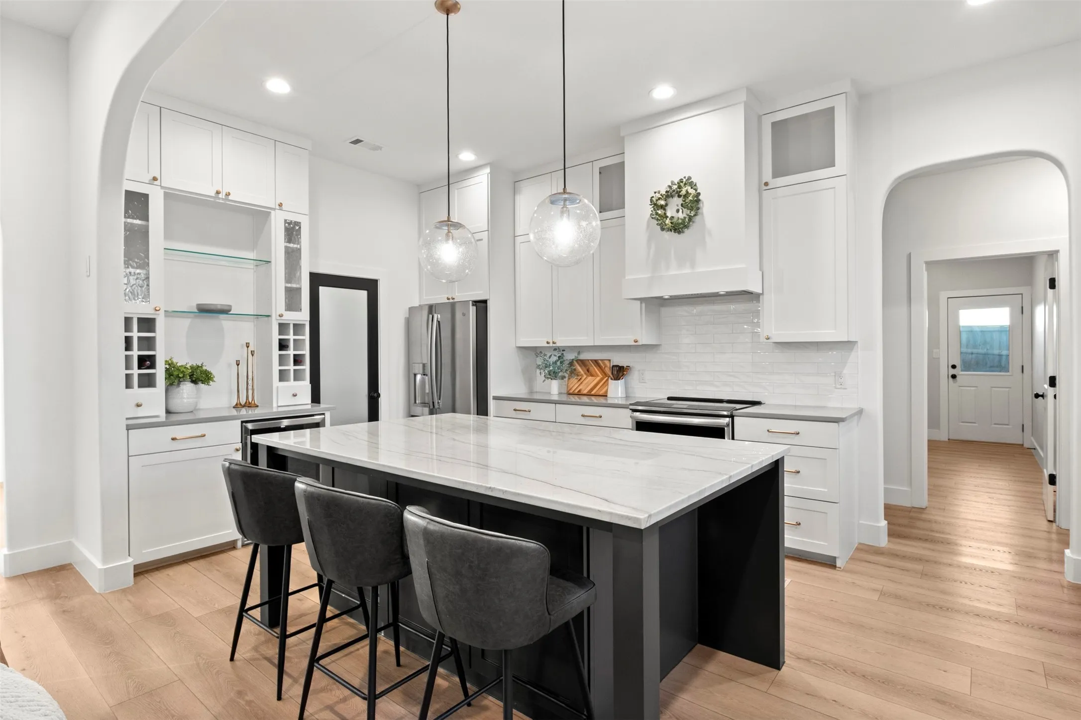 Ceiling-height cabinetry, warm brass accents and an oversized island create a standout kitchen.