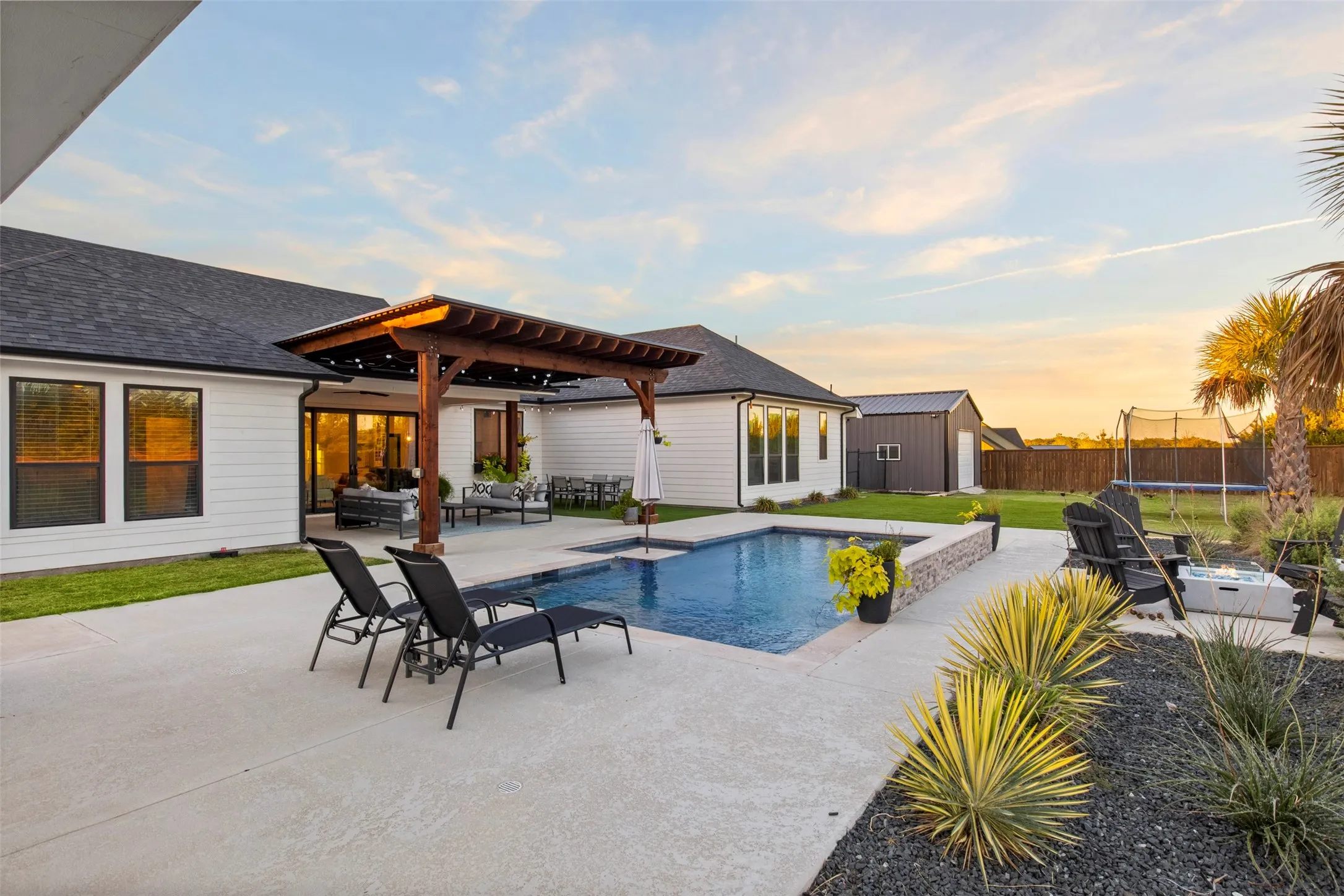 The pool, outdoor living area and separate pool house create a backyard designed to be enjoyed.