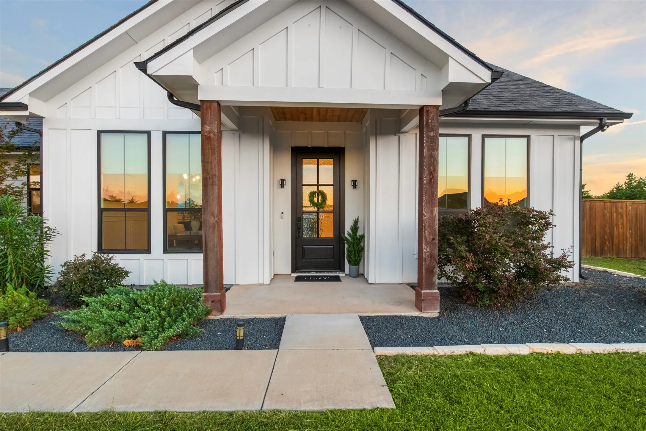 Covered front entry with natural wood accents and distinctive custom details.