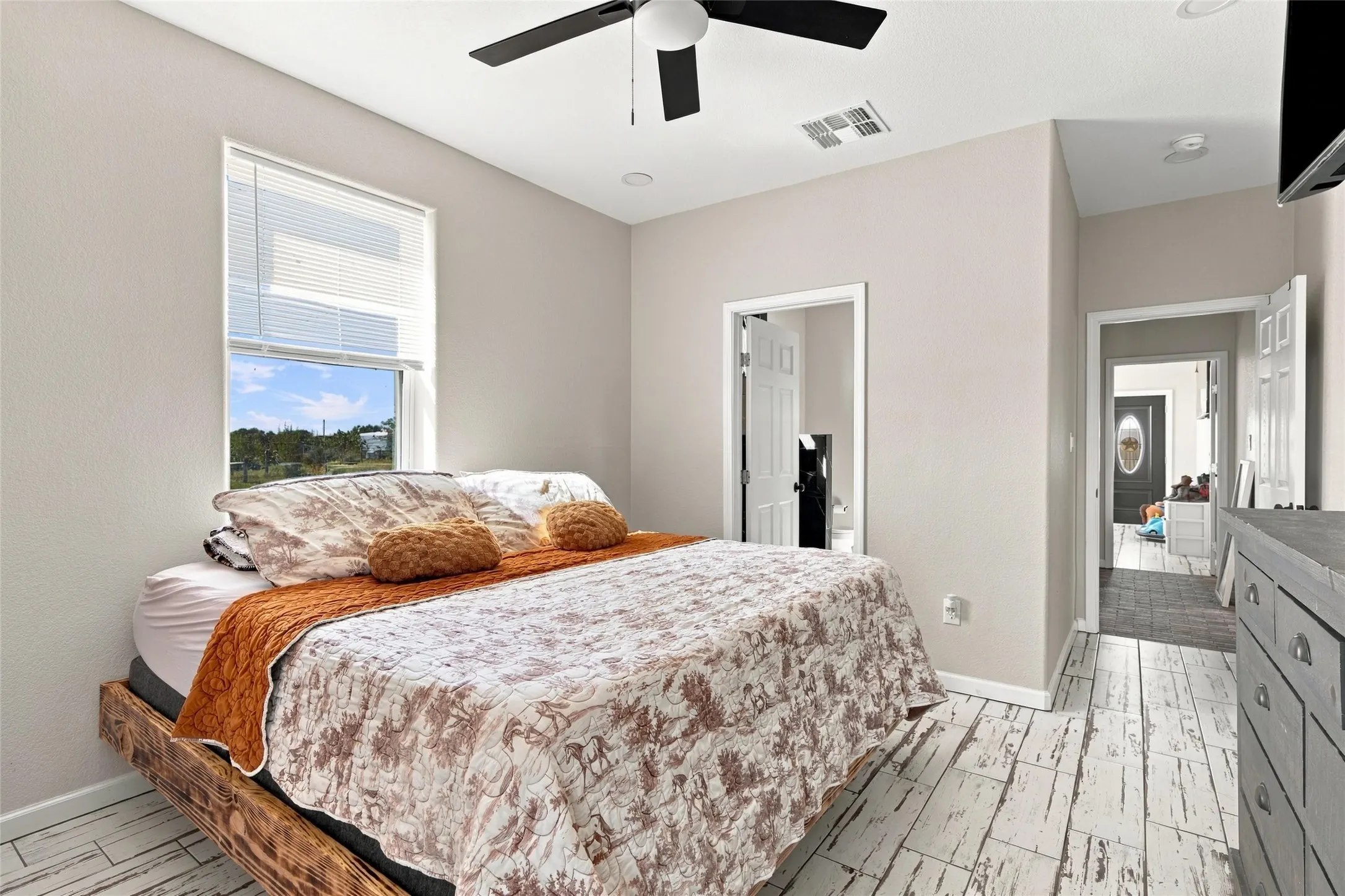 Wood-finish flooring, ceiling fan, and recessed lighting