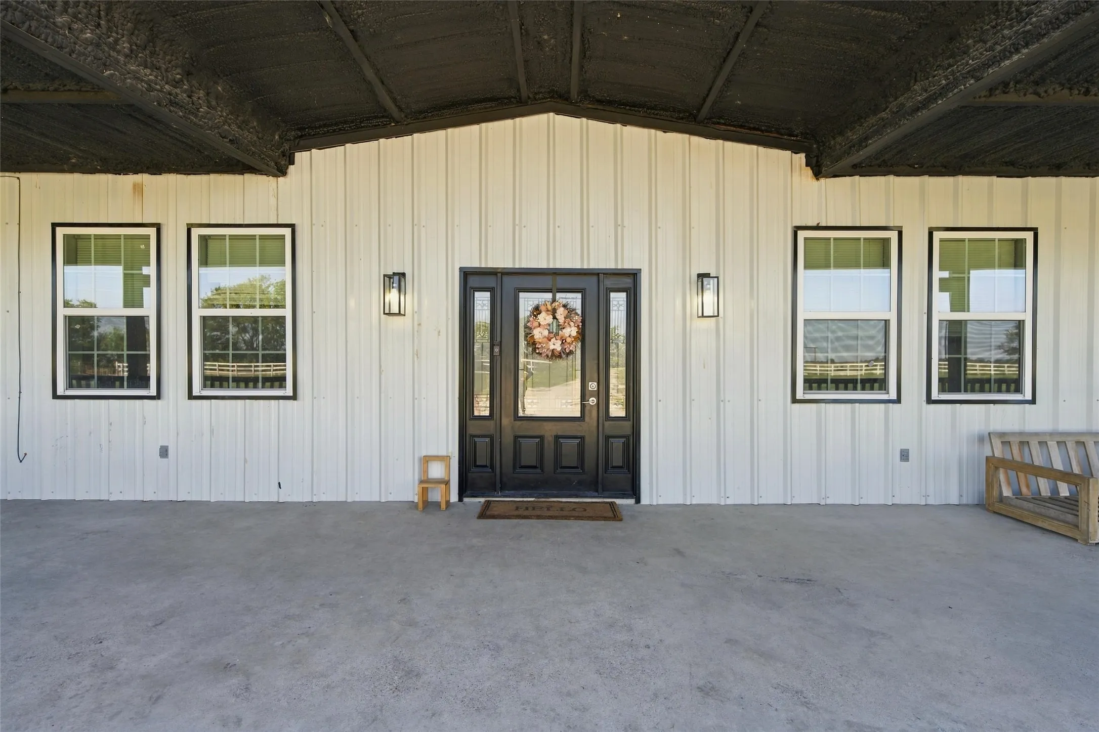 White vertical panel siding with black trim windows