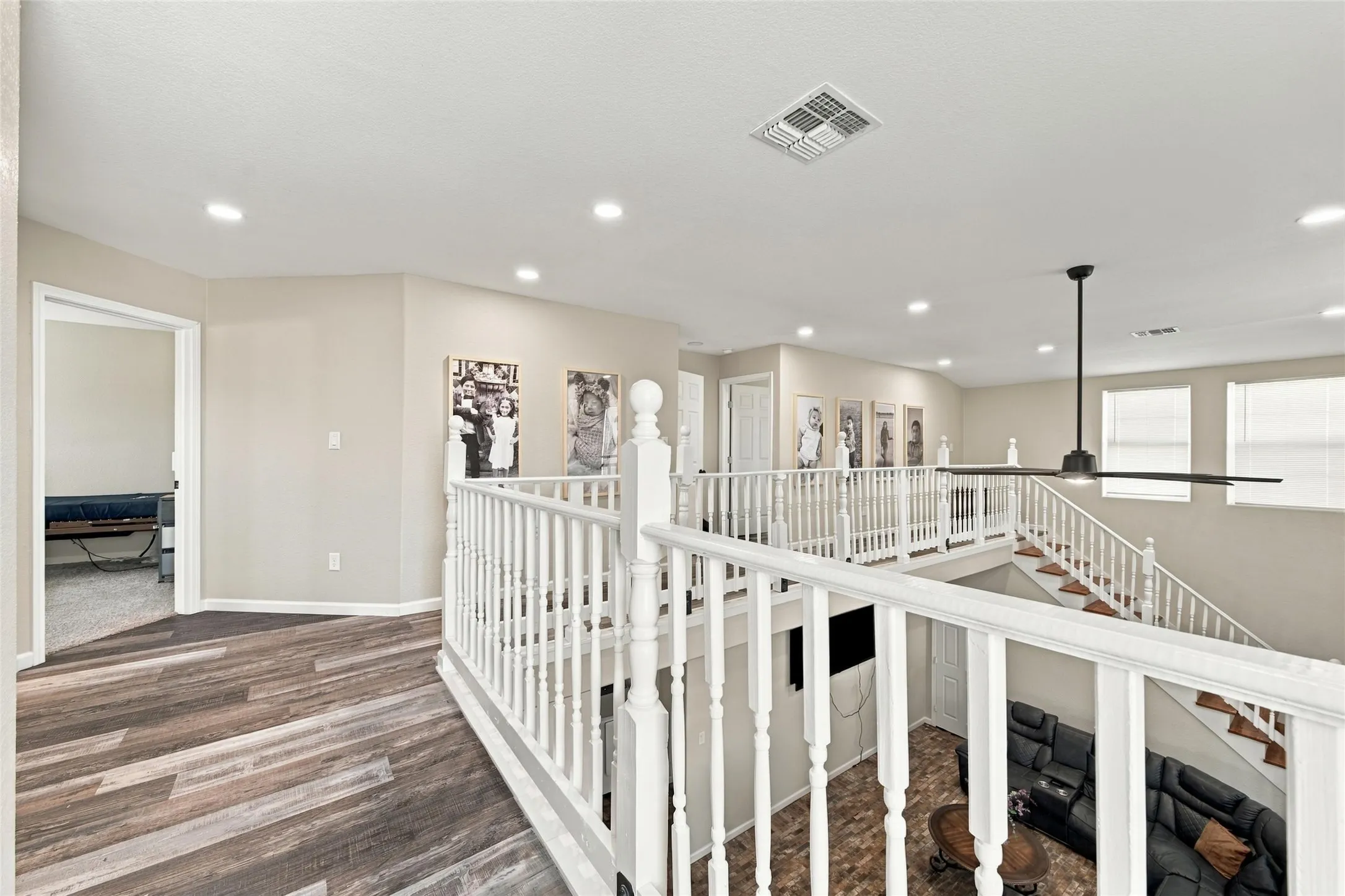 Upper level featuring wood-finish flooring, recessed lighting, and a contemporary ceiling fan