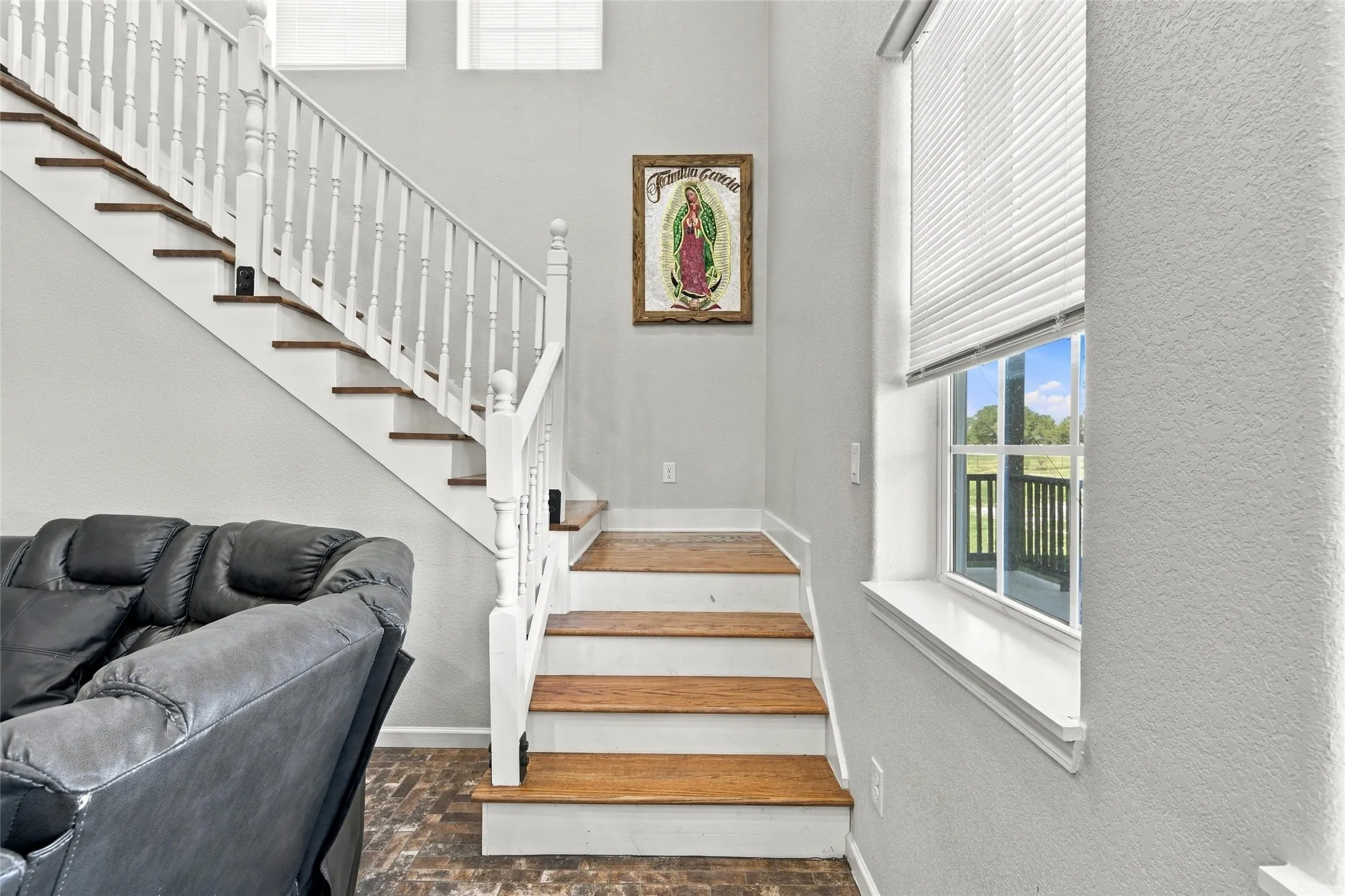 Staircase with wood-finish treads and white balusters