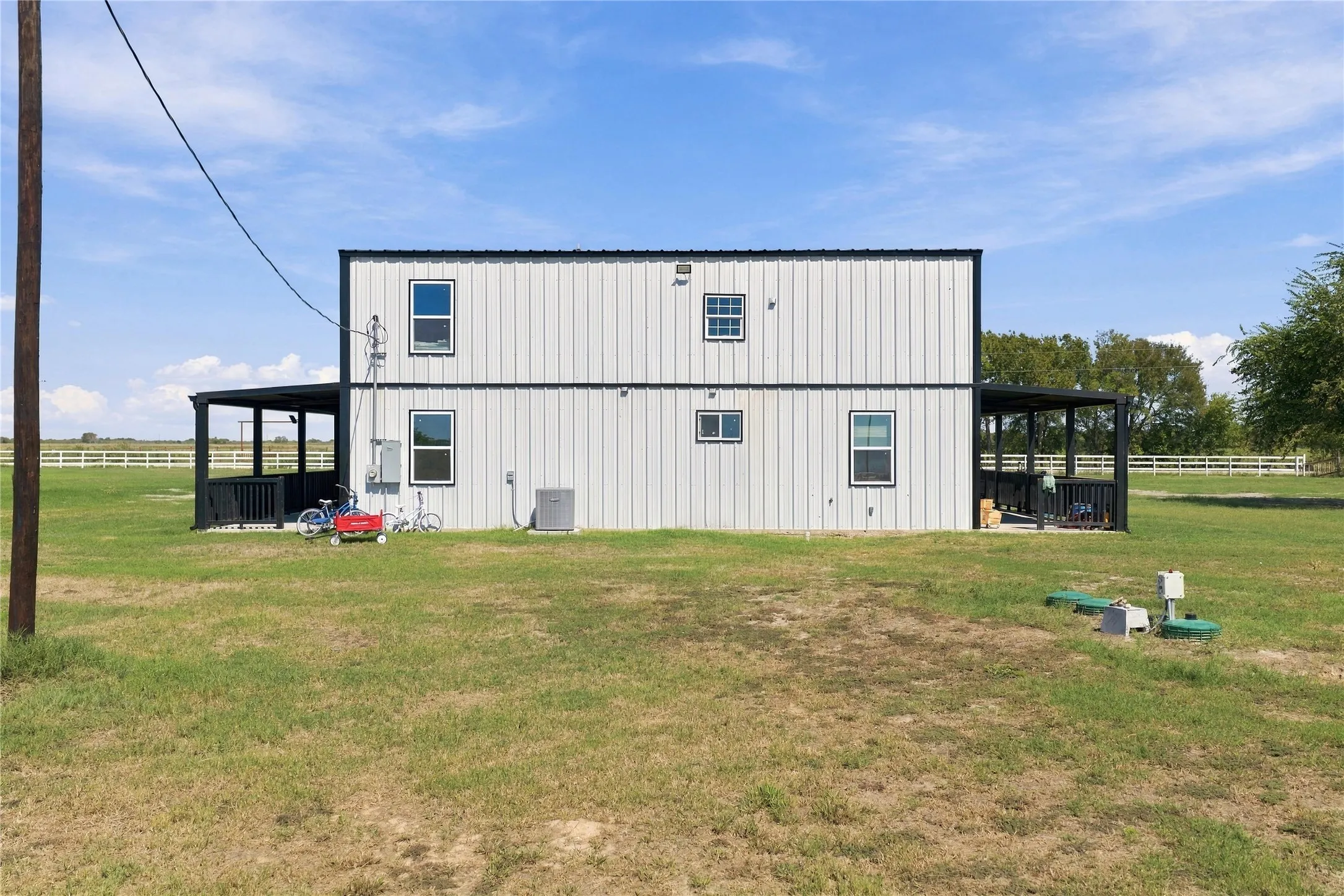 Two-story structure with vertical panel siding