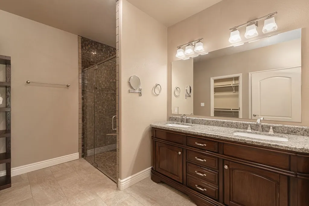 Recessed built-in shelving, wood-finish flooring, and crown molding details