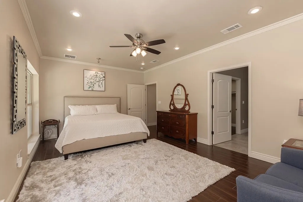 Recessed lighting, crown molding, wood-finish flooring, ceiling fan, and expansive windows