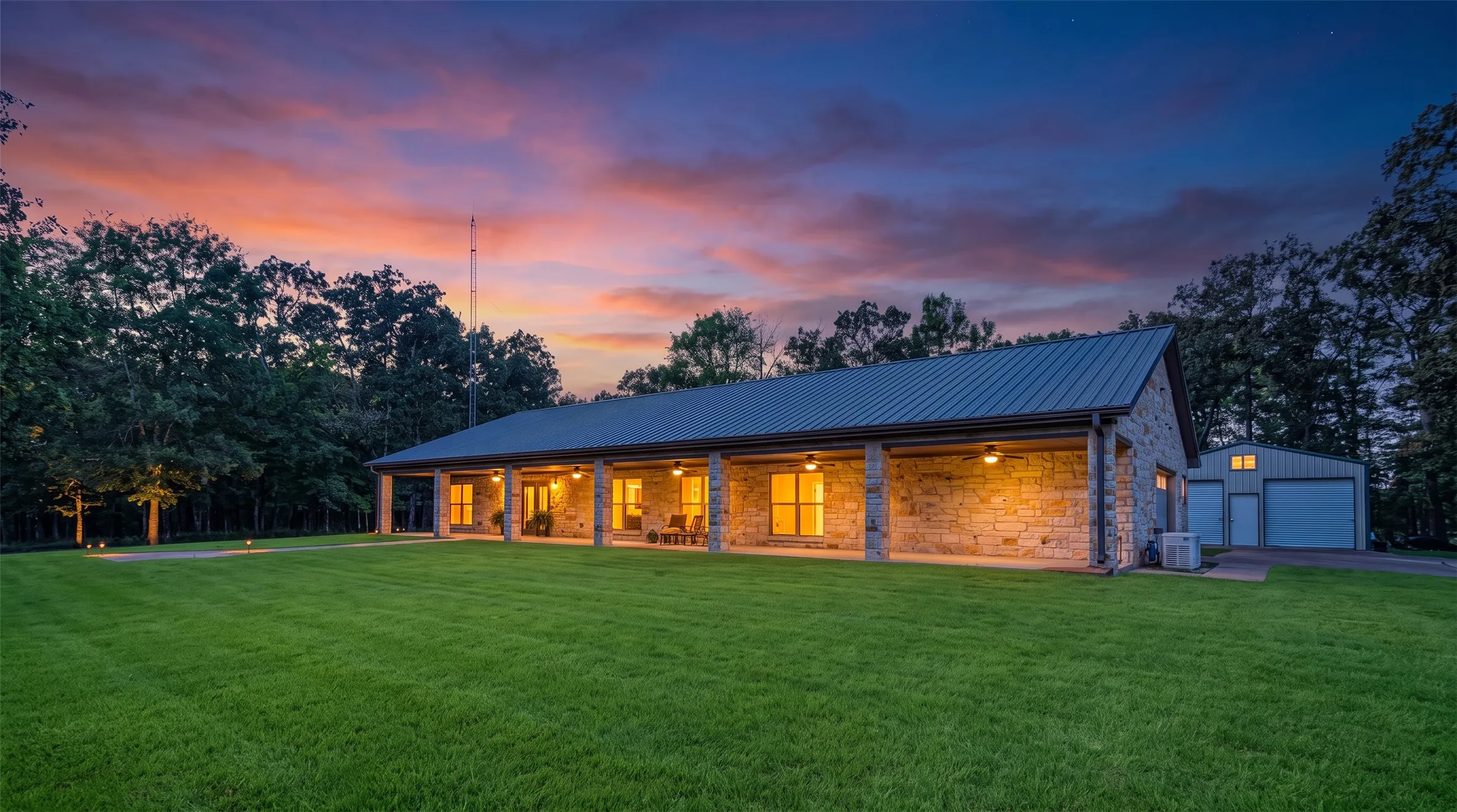 Stone exterior with a metal roof, featuring a covered front porch with recessed lighting