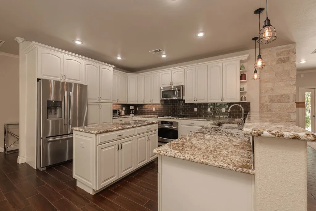 Recessed lighting, crown molding, wood-finish flooring, French doors, and an elongated pendant light fixture