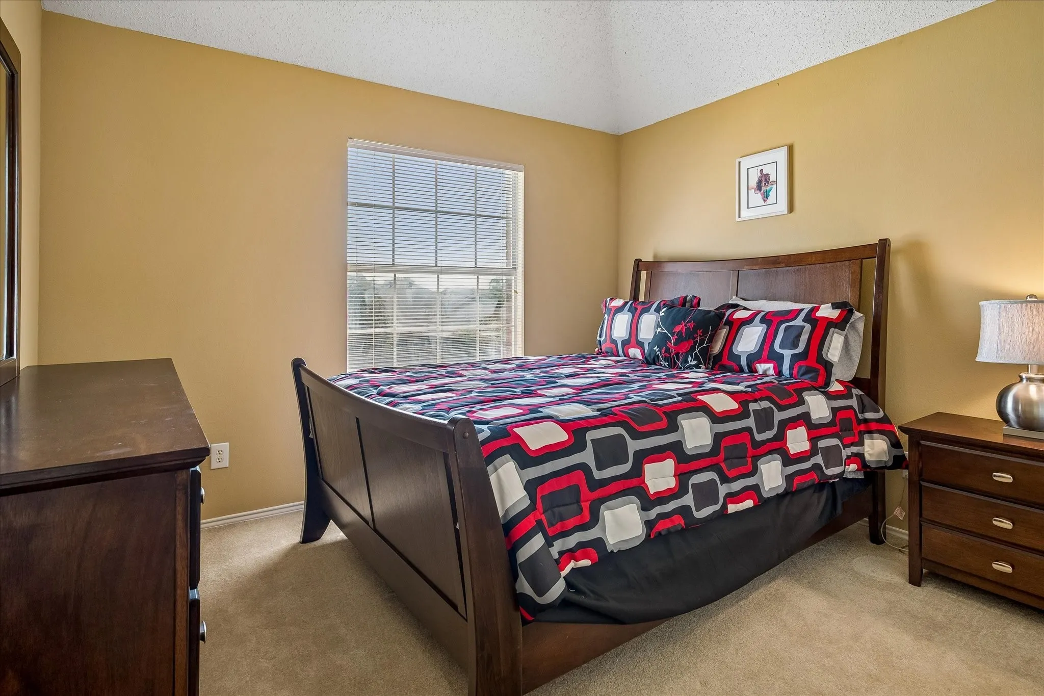 Vaulted ceilings and window featuring natural light