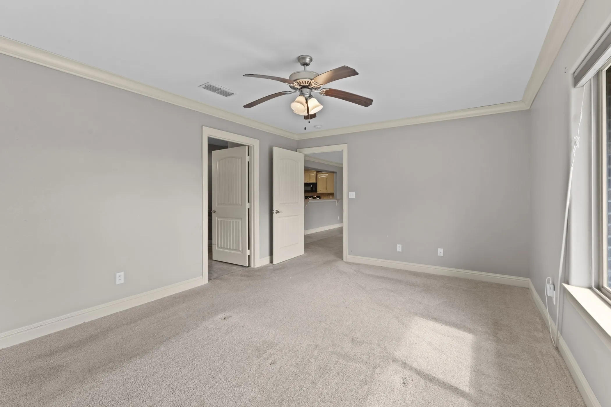 Recessed lighting, crown molding, ceiling fan, carpet flooring, and white trim