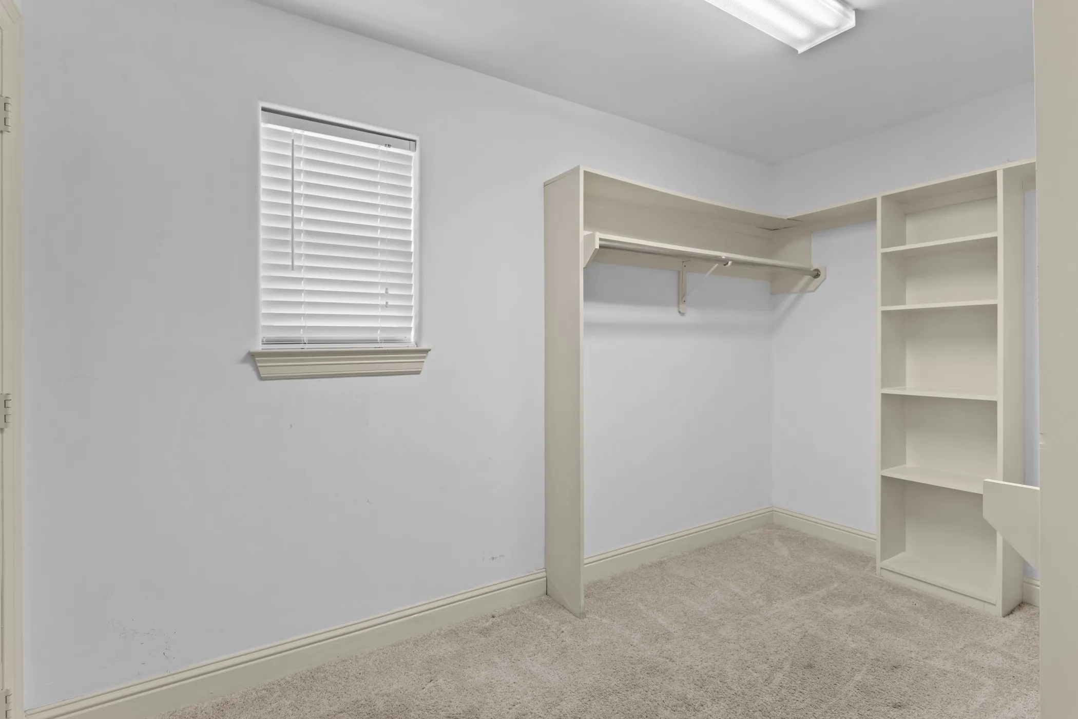 Built-in closet system featuring shelving and hanging rods