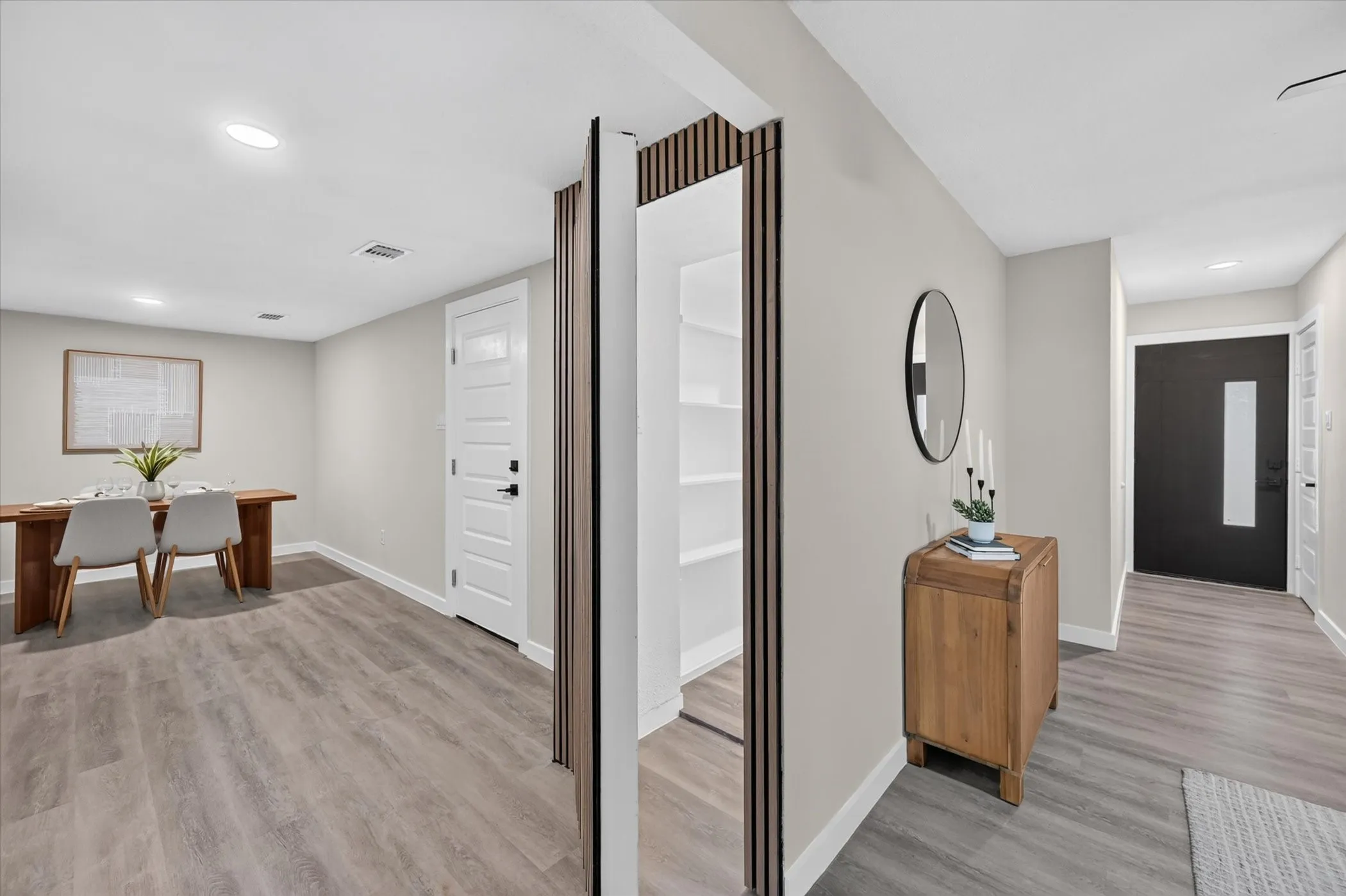 Recessed lighting, wood-finish flooring, pantry with built-in shelving, paneled interior doors, and a front entry door with a frosted glass insert