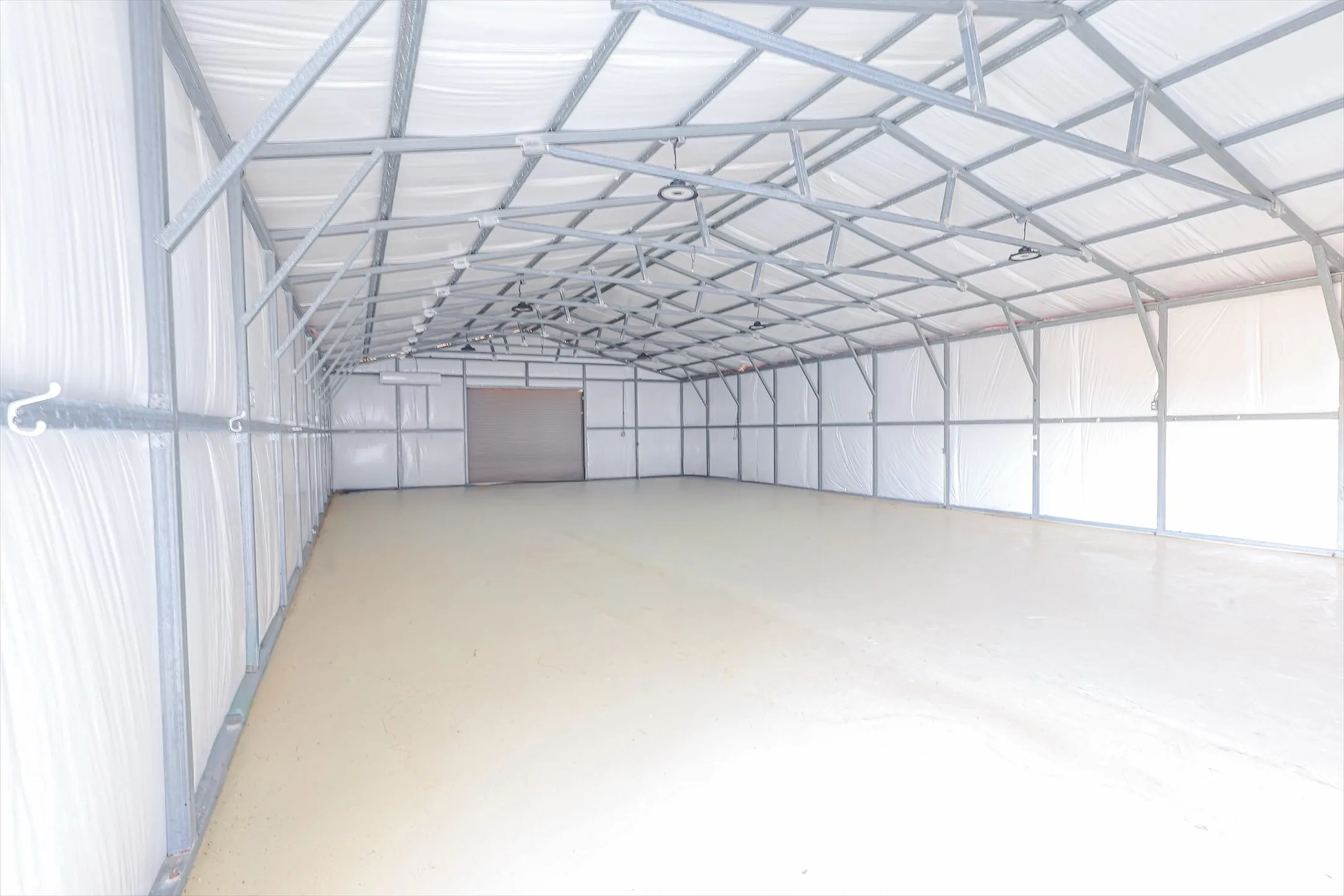Interior of insulated shop with 2 roll up doors.