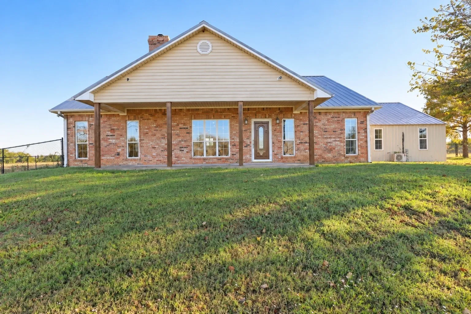 Brick ranch on 6+ acres with 2 shops, pond and greenhouse