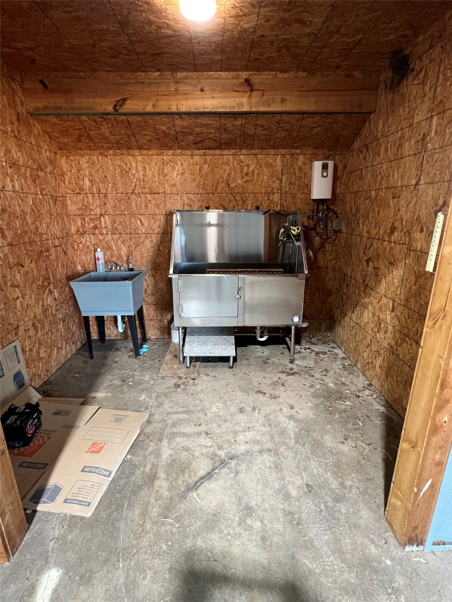 Professional dog washing station with hot and cold water, climate control and separate sink.