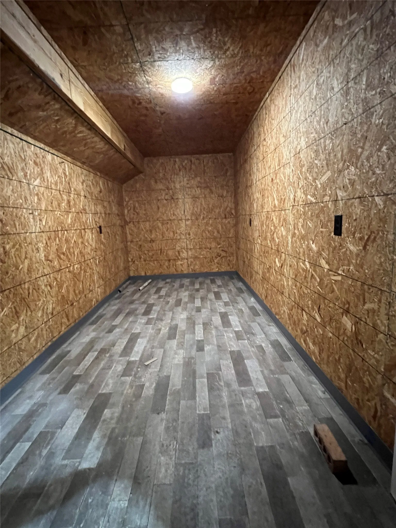 Back section of storage room accessed from separate door at rear of quonset hut
