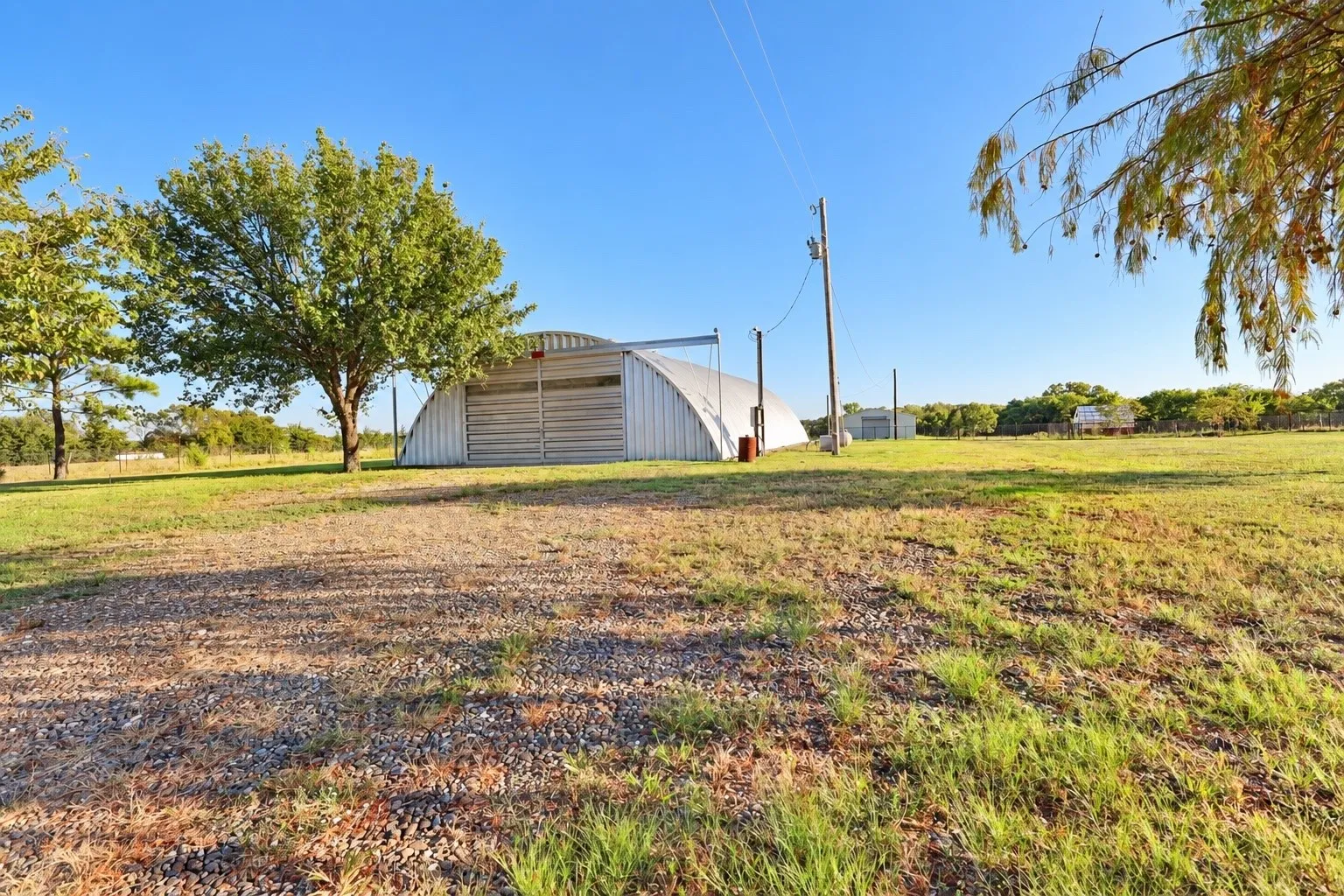 View from back porch to 48' x 80' Quonset hut with shop with 200 AMP electrical and plumbing.