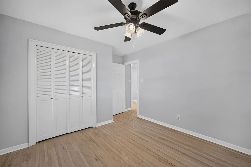 Light wood-finish flooring with white baseboards