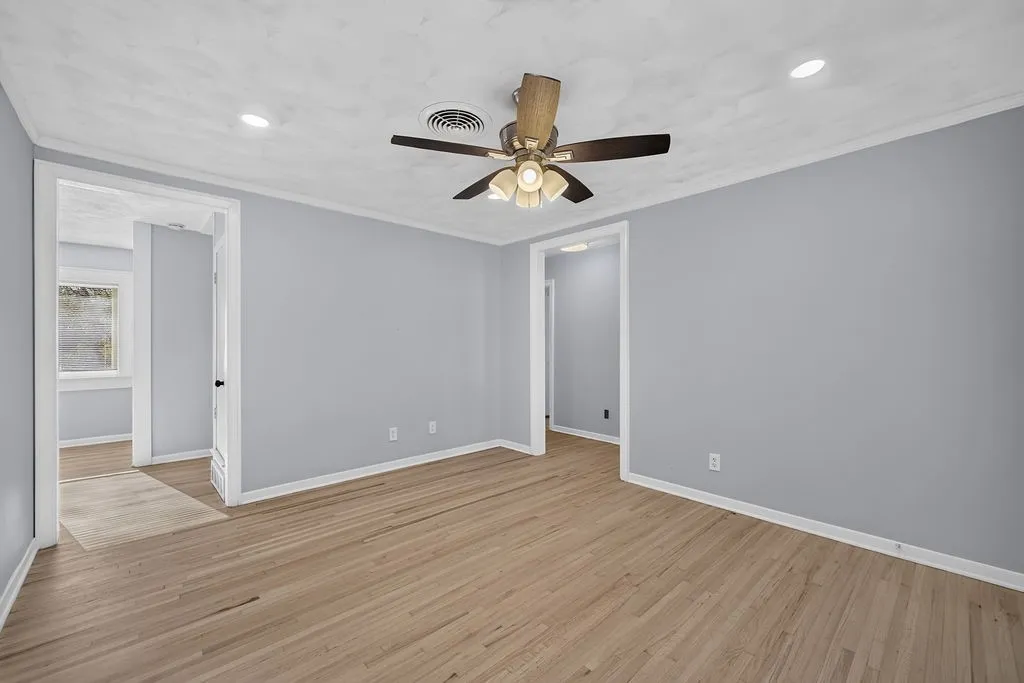 Wood-finish flooring, recessed lighting, and a ceiling fan with integrated lighting