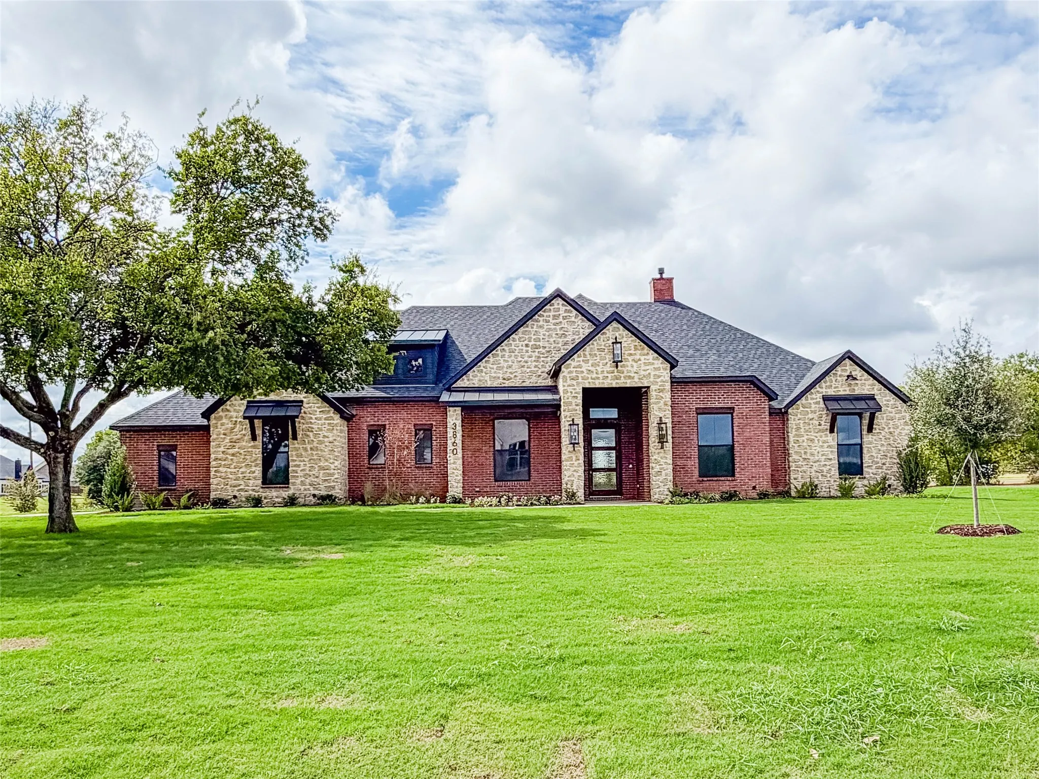 Brick and stone exterior with dark trim accents