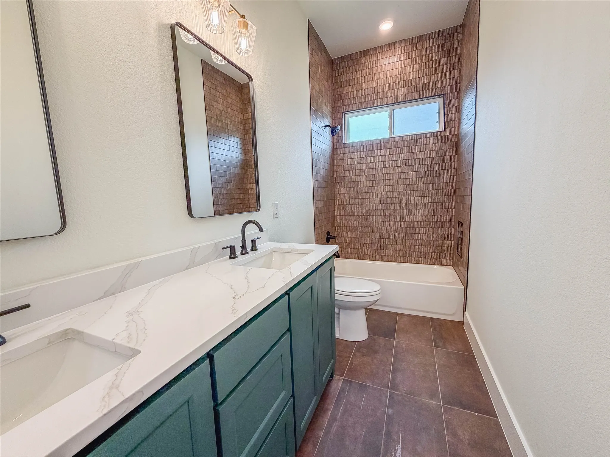 Dual vanity with a white countertop and integrated sinks, dark green cabinetry, and rectangular mirrors