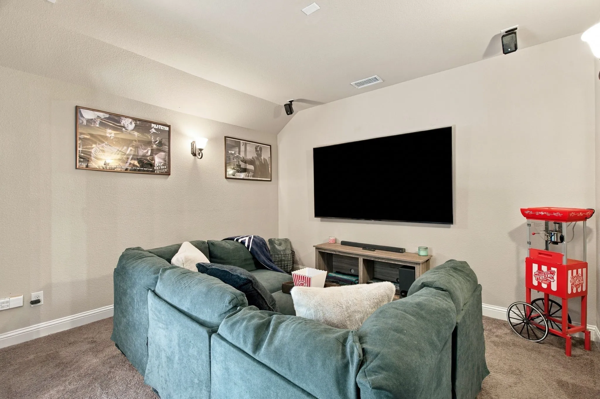 Dedicated media room with built-in speakers, and comfortable space for theater-style seating and movie nights.