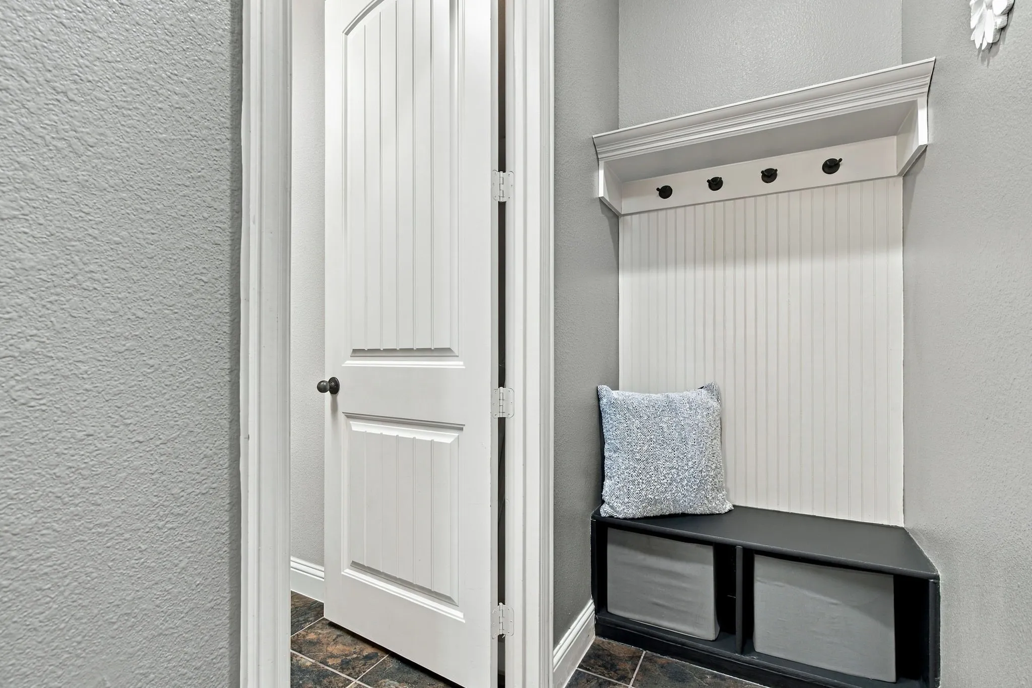 Practical built-in mud room area between the 2-car garage and laundry room—perfect for keeping everyday essentials organized.