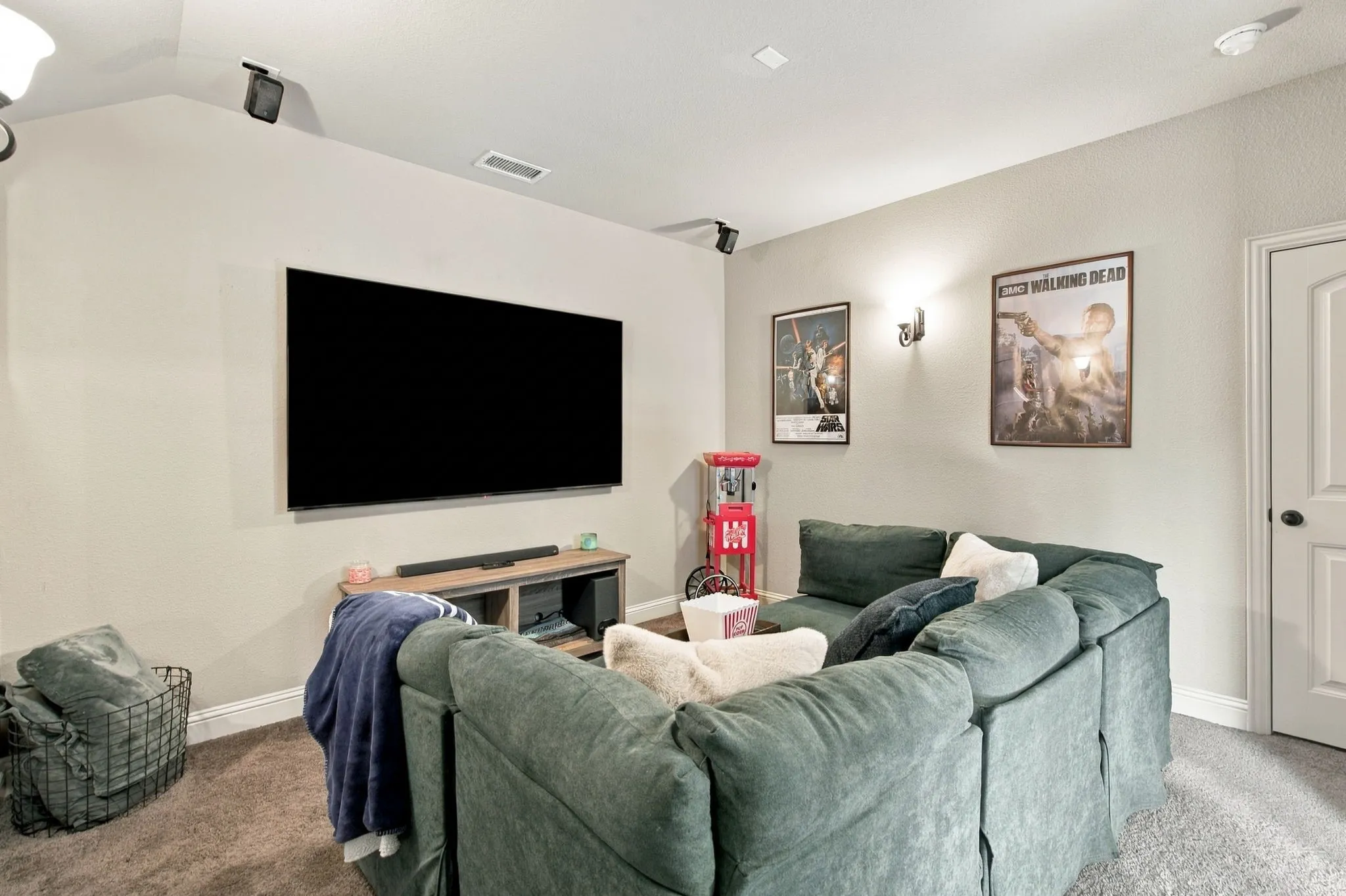Dedicated media room with built-in speakers, and comfortable space for theater-style seating and movie nights.