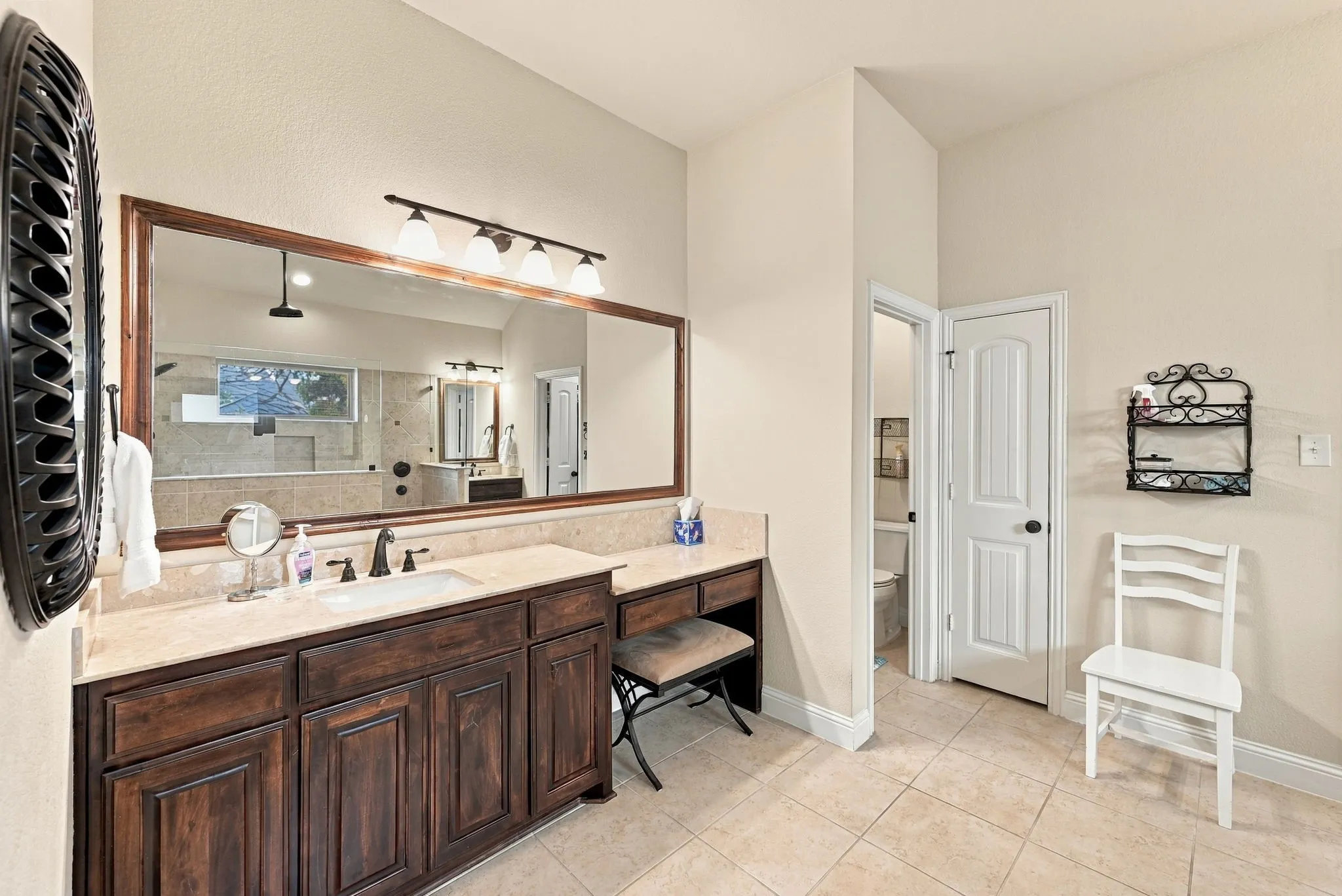 Primary ensuite bathroom with vanity and separate sink areas.
