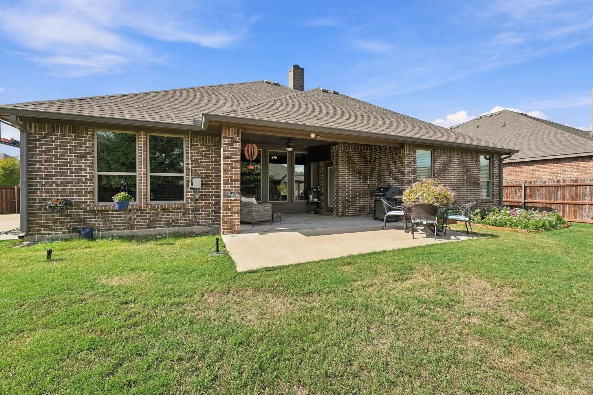 Gorgeous and spacious back yard with covered and extended patio.