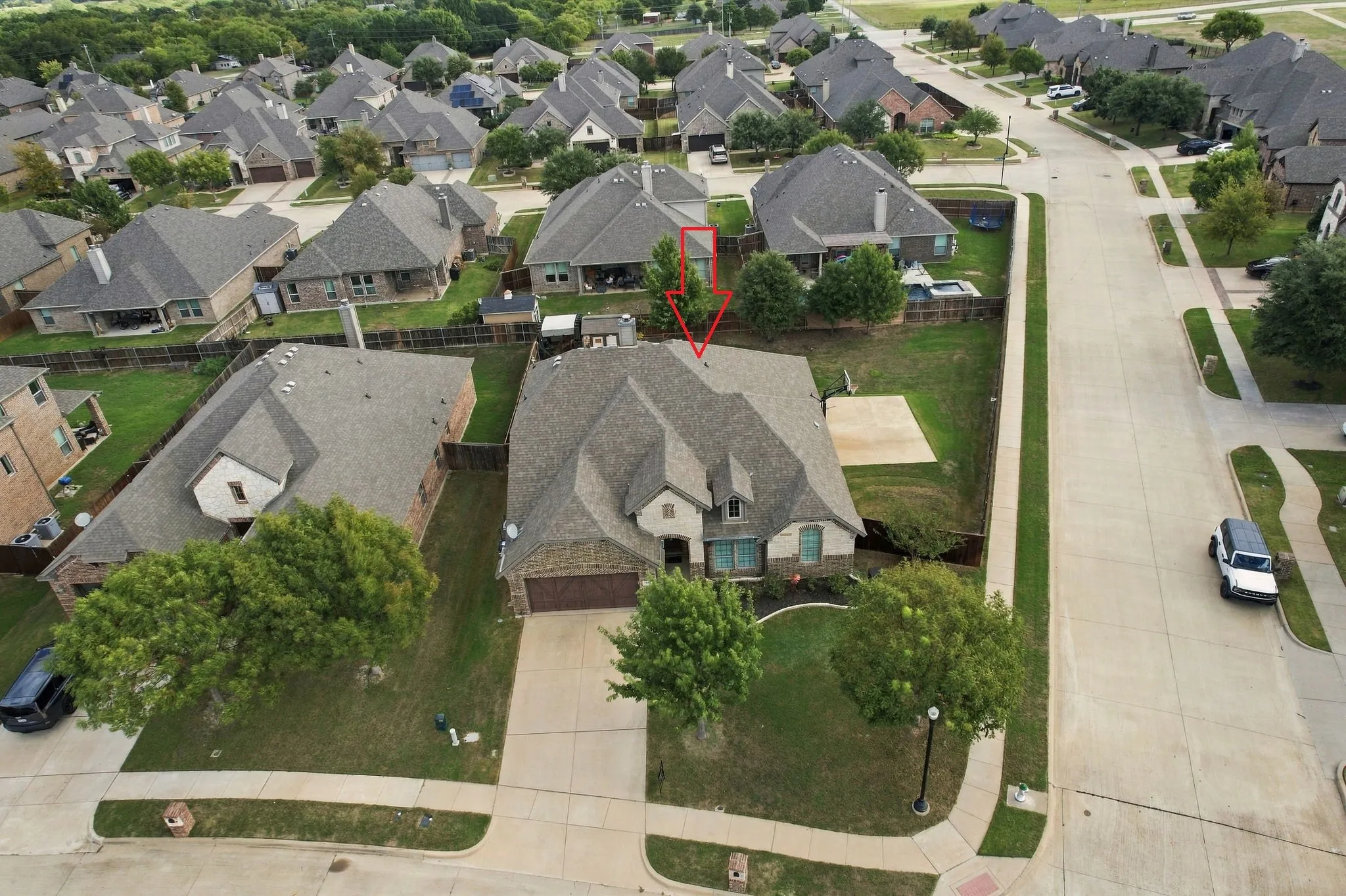 Aerial view of the oversized corner lot with mature trees.