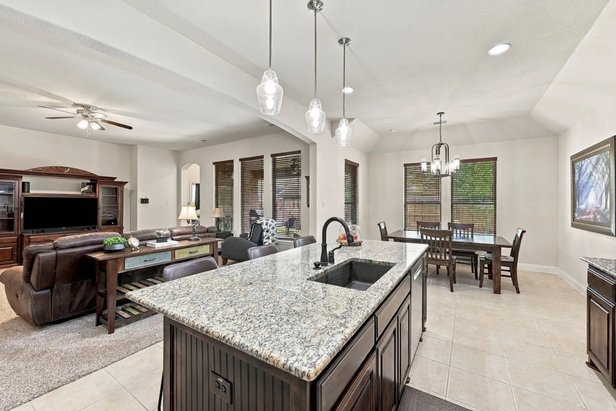View from the kitchen into the breakfast area, open to the expansive living room.