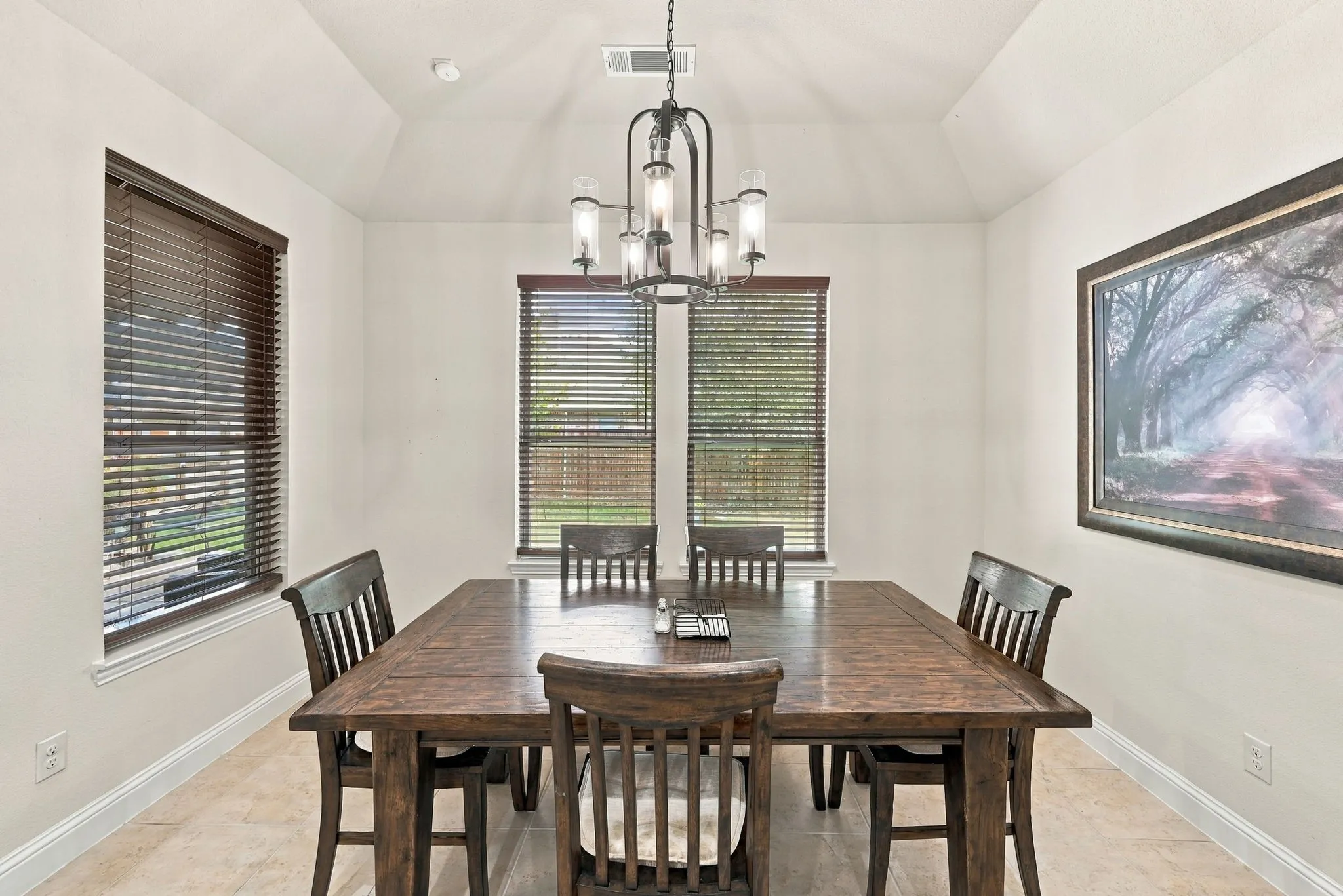 Spacious breakfast area with natural light and wood blinds. Notice the chandelier!