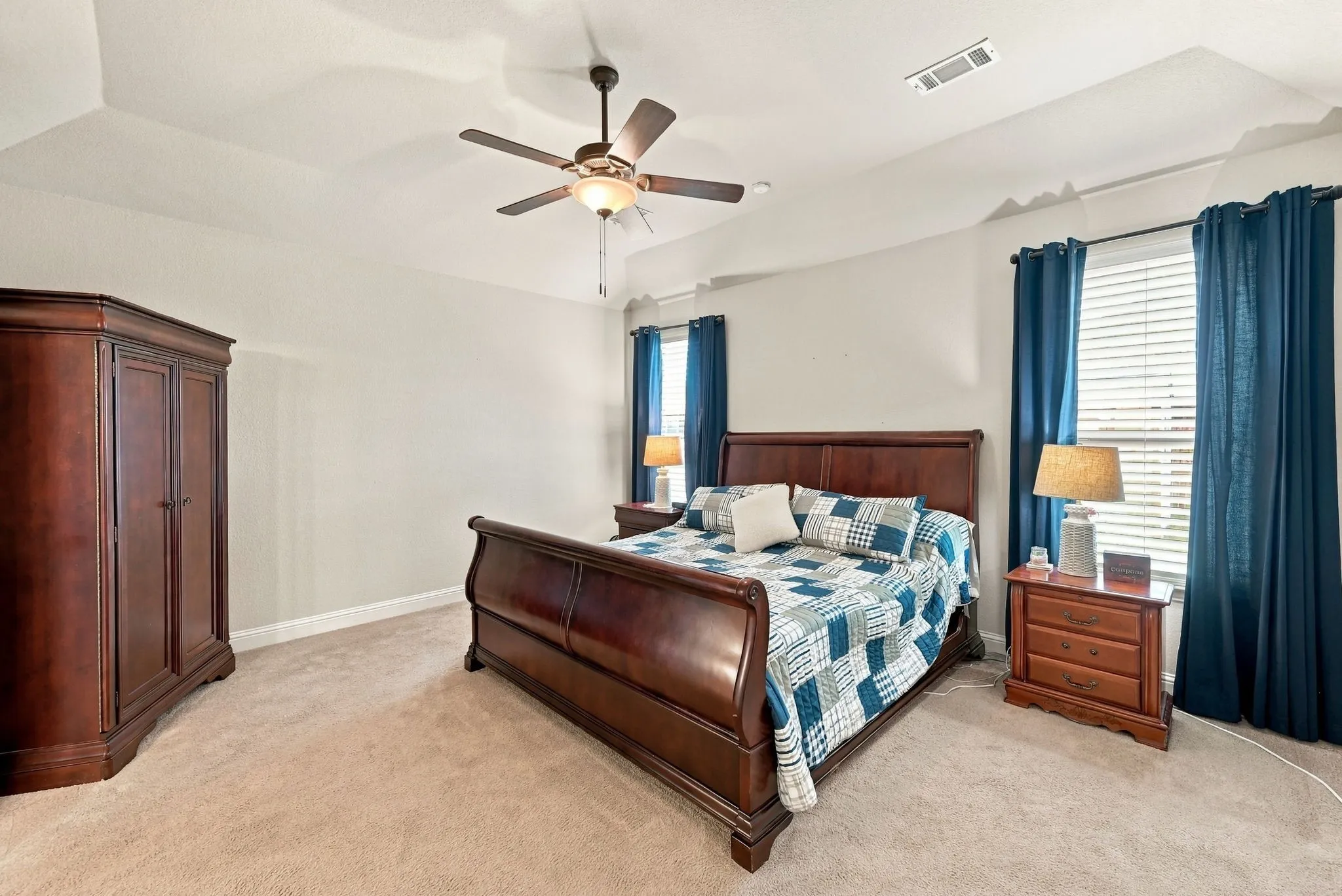 Primary bedroom with natural light and beautiful tray celing.