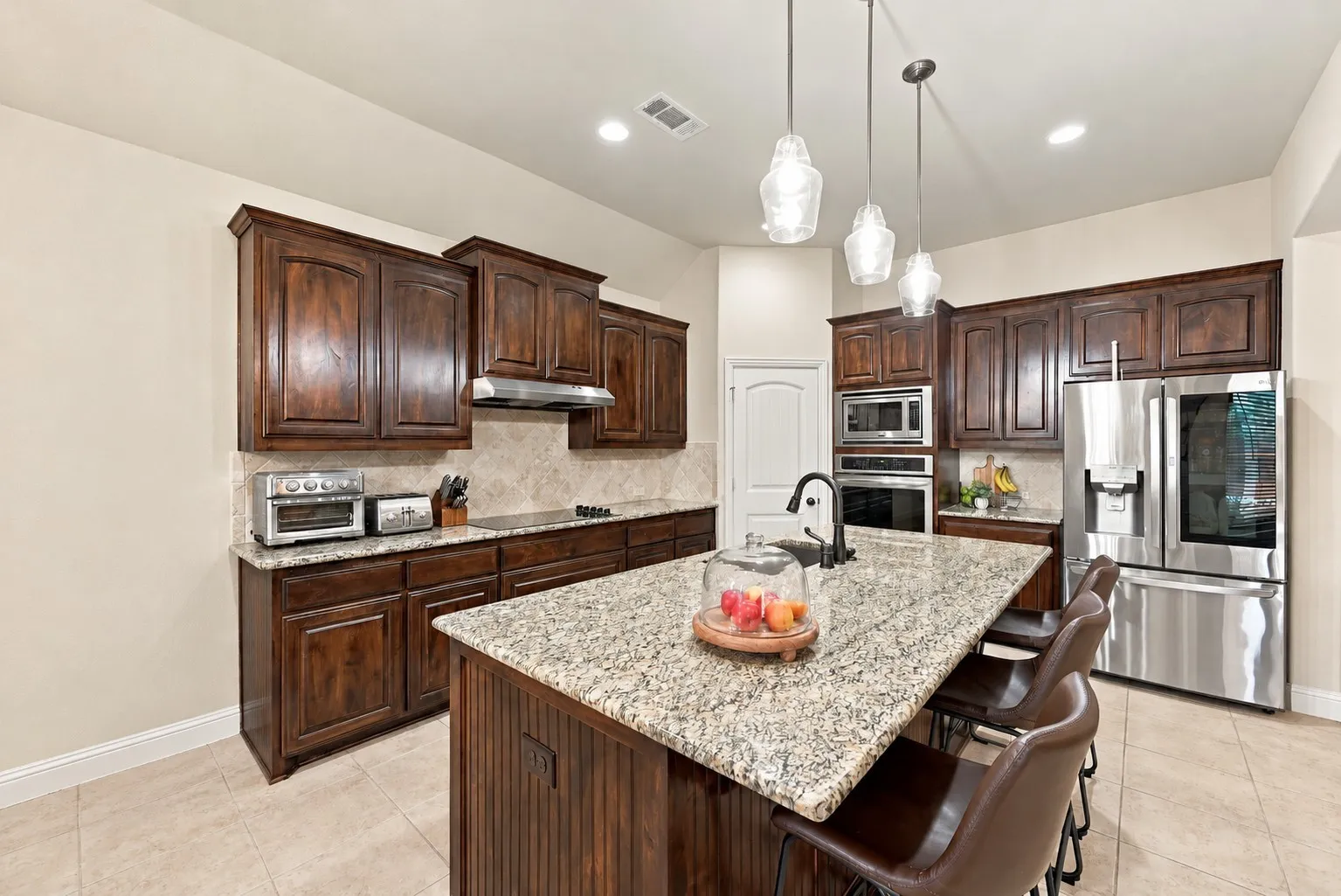 Beautiful kitchen with granite countertops and large kitchen island.