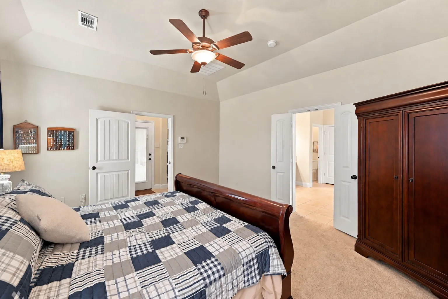 Another view of the primary bedroom facing the ensuite bathroom.