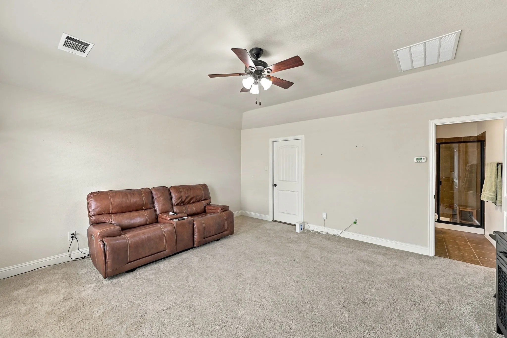 Another view of the upstairs game room featuring the full bath and attic access door.