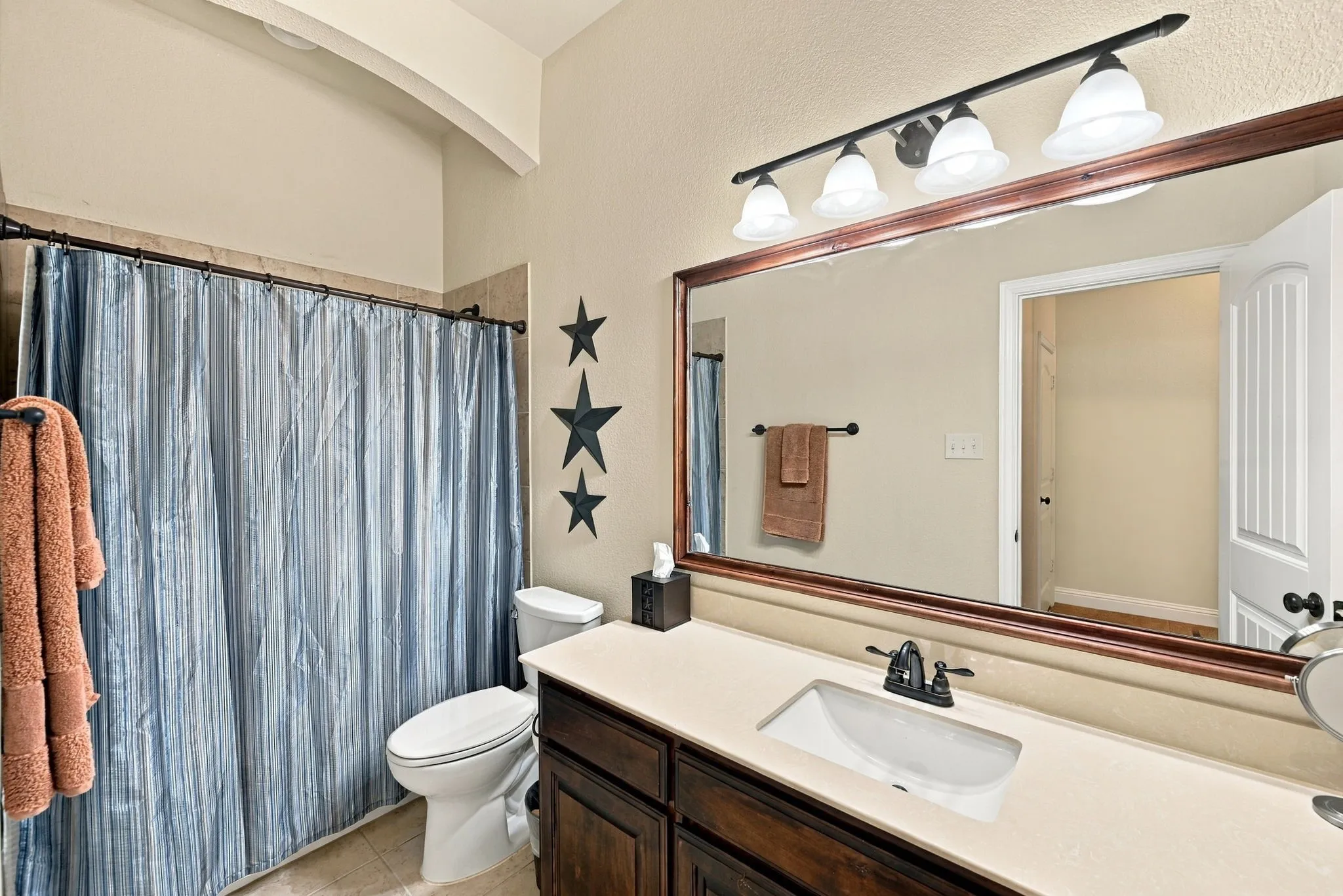 Guest bathroom with large countertop space and shower/tub combo.