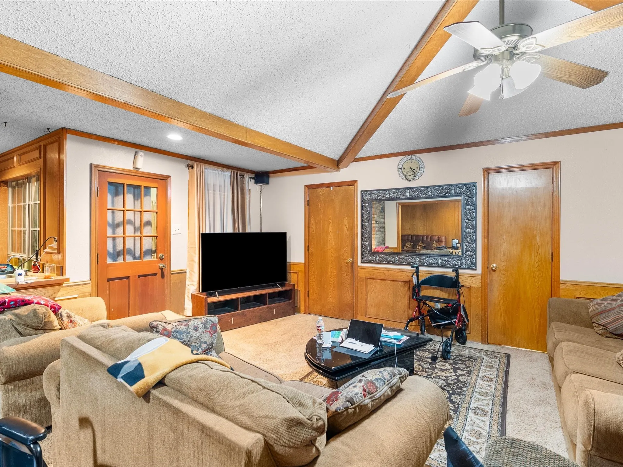 Wood-paneled walls and ceiling beams