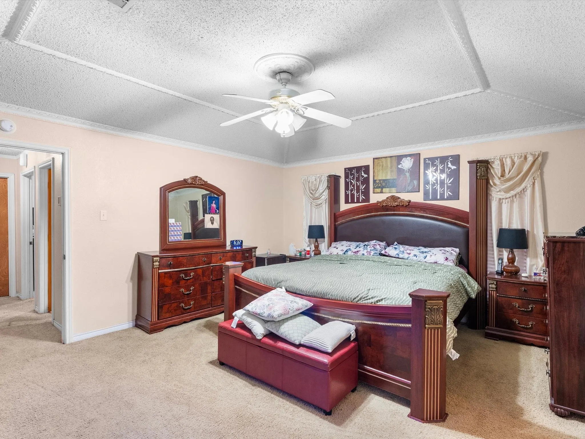 Recessed ceiling detail with an overhead fan, crown molding, and neutral wall tones