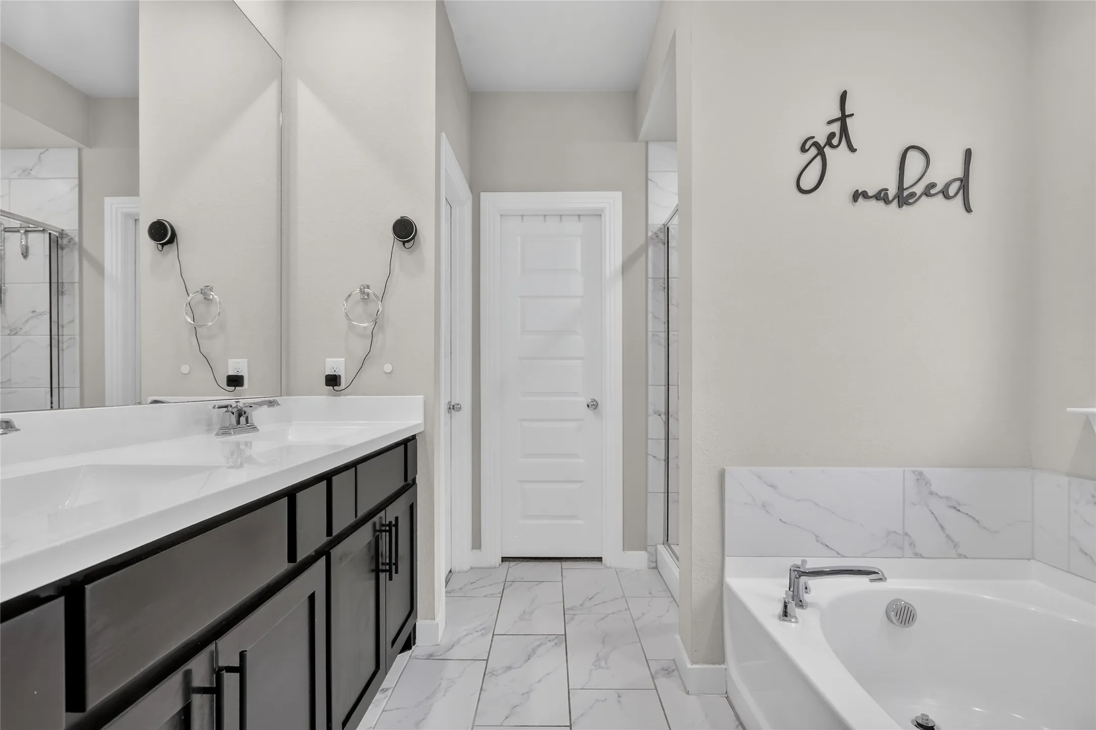 Double vanity with undermount sinks, chrome fixtures, and dark wood-finish cabinetry