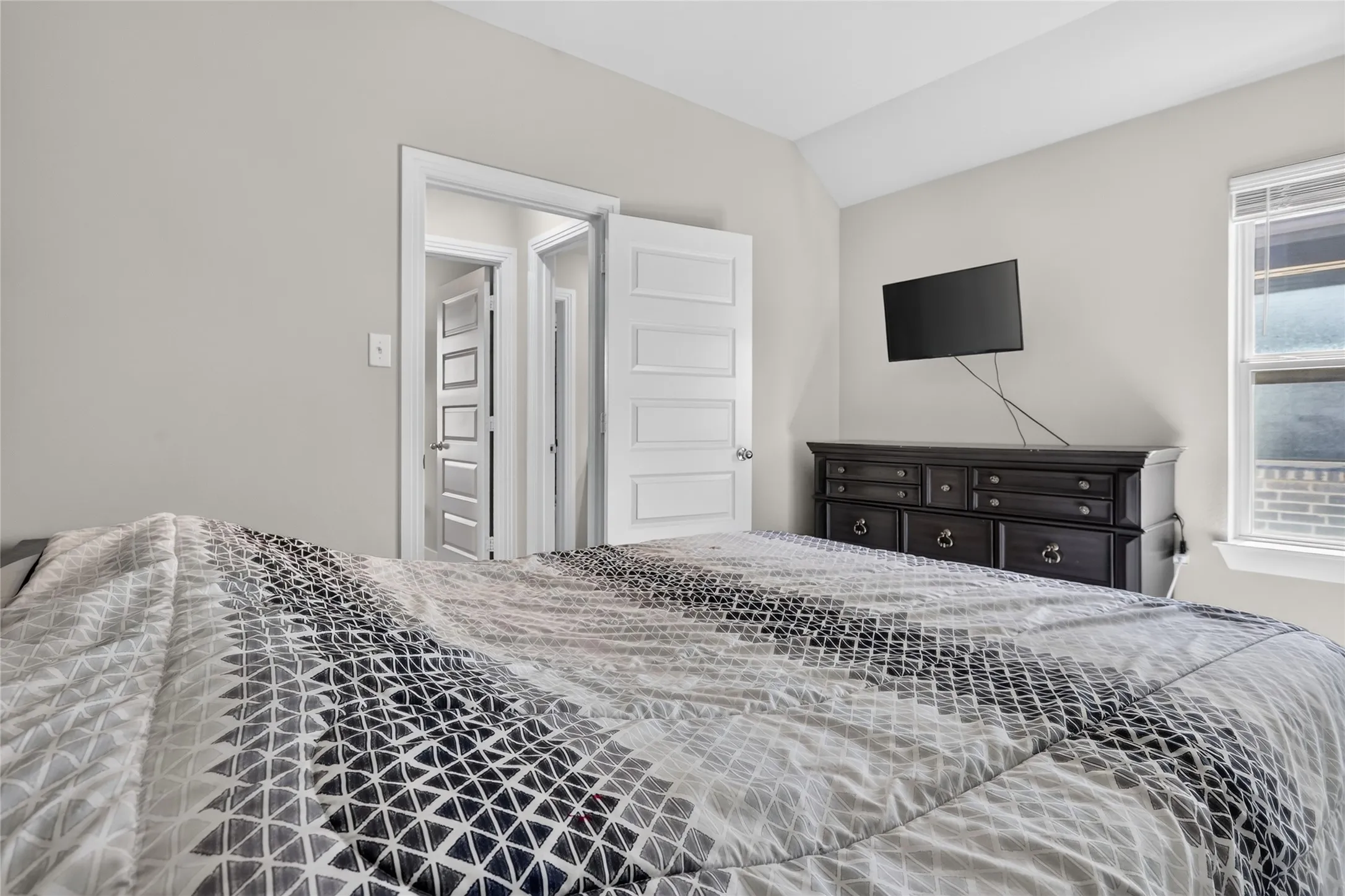 Recessed lighting and a window with blinds provide illumination