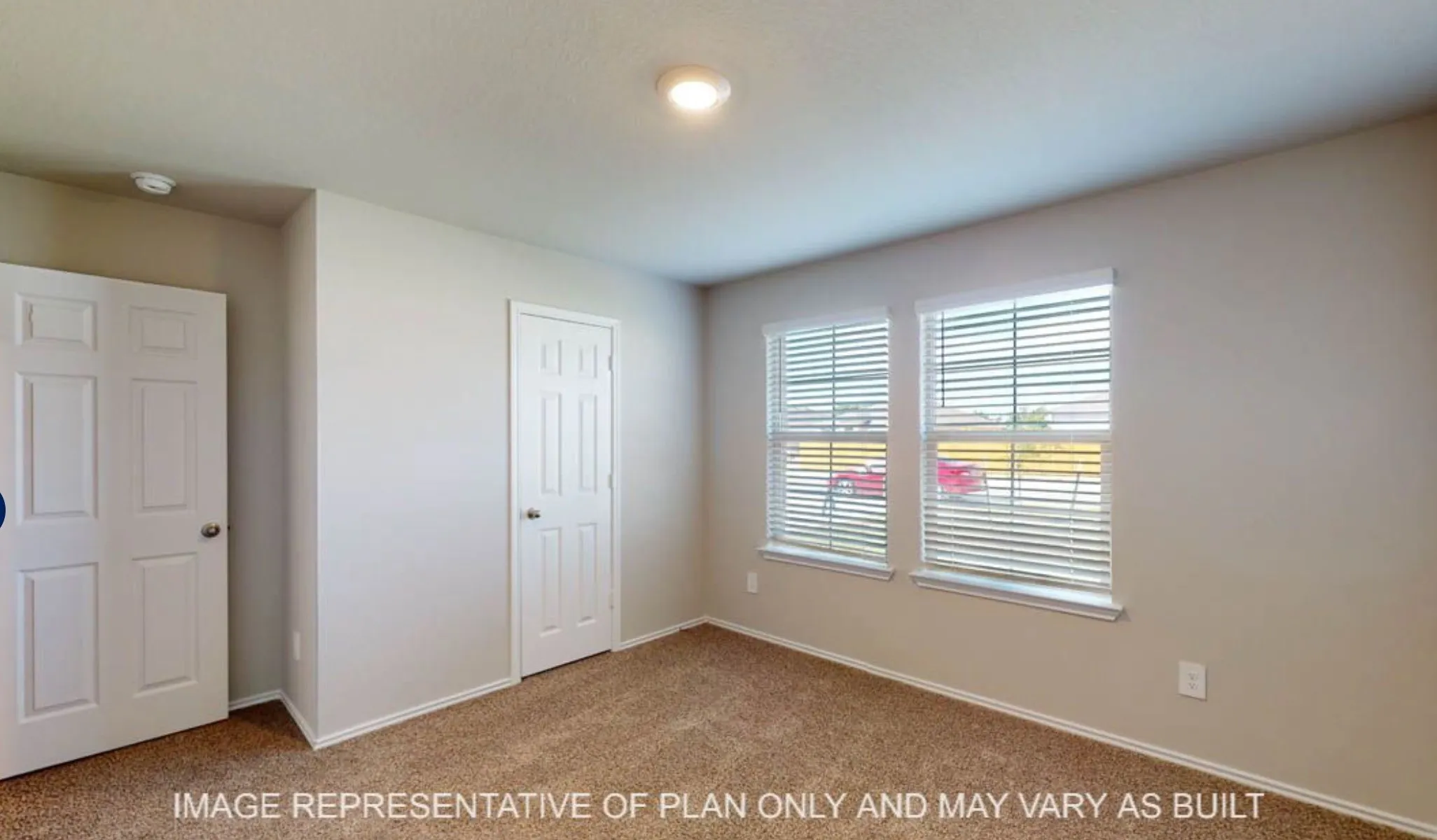 Neutral tone wall paint, two white paneled doors, two windows with blinds, and recessed lighting