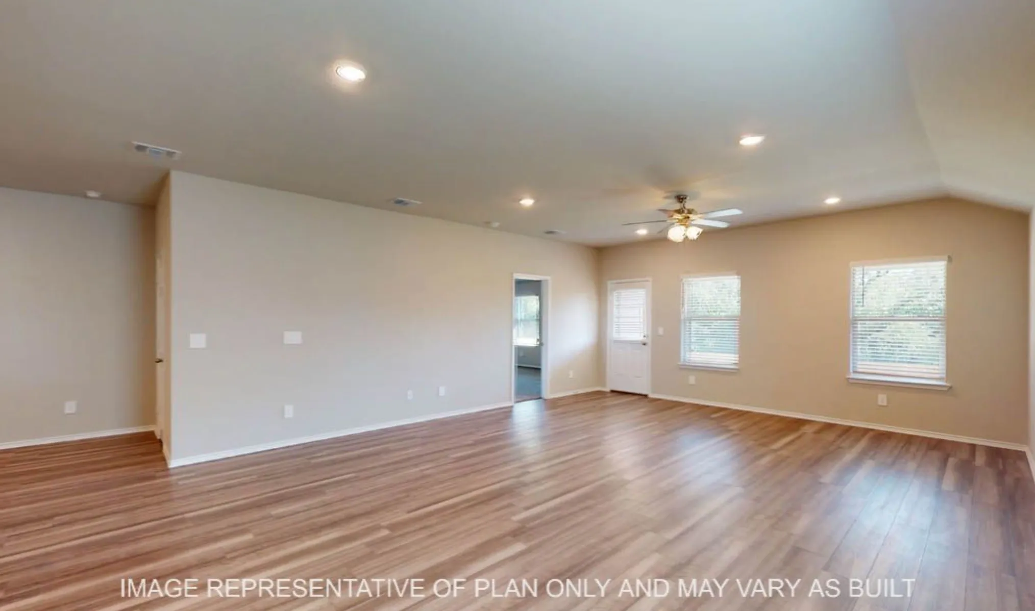 Vaulted ceiling, wood-finish flooring, recessed lighting, ceiling fan, and multiple windows