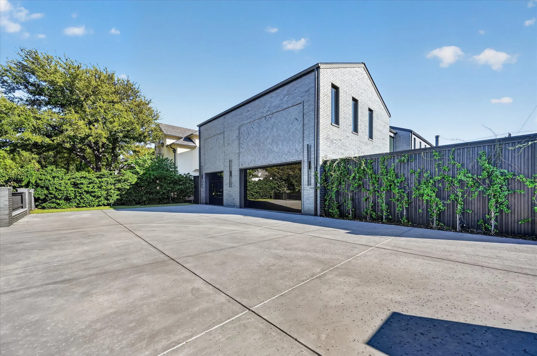 Gray brick exterior featuring multiple windows and a metal roof